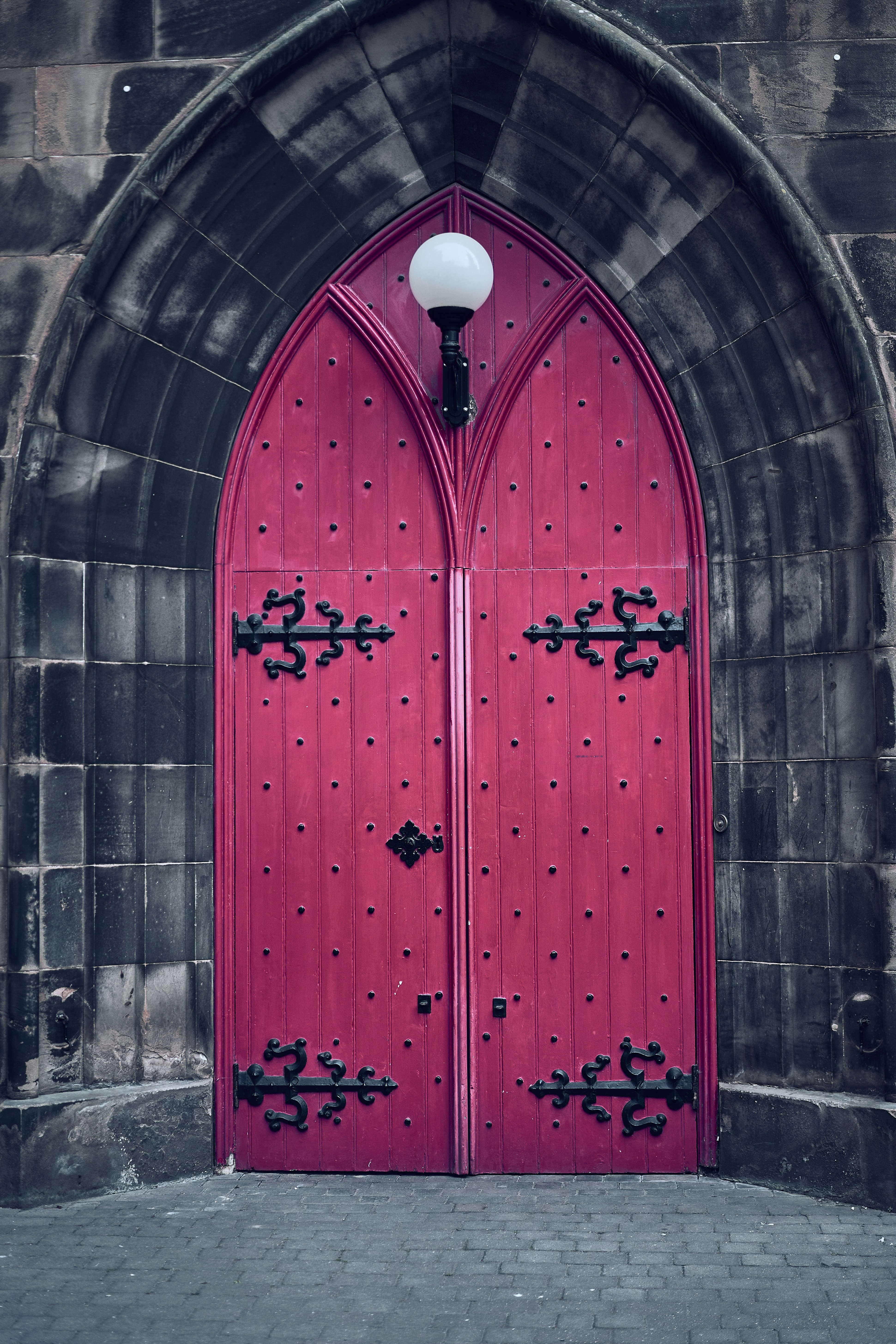 A red Gothic doorway in Edinburgh's Old Town, Scotland.