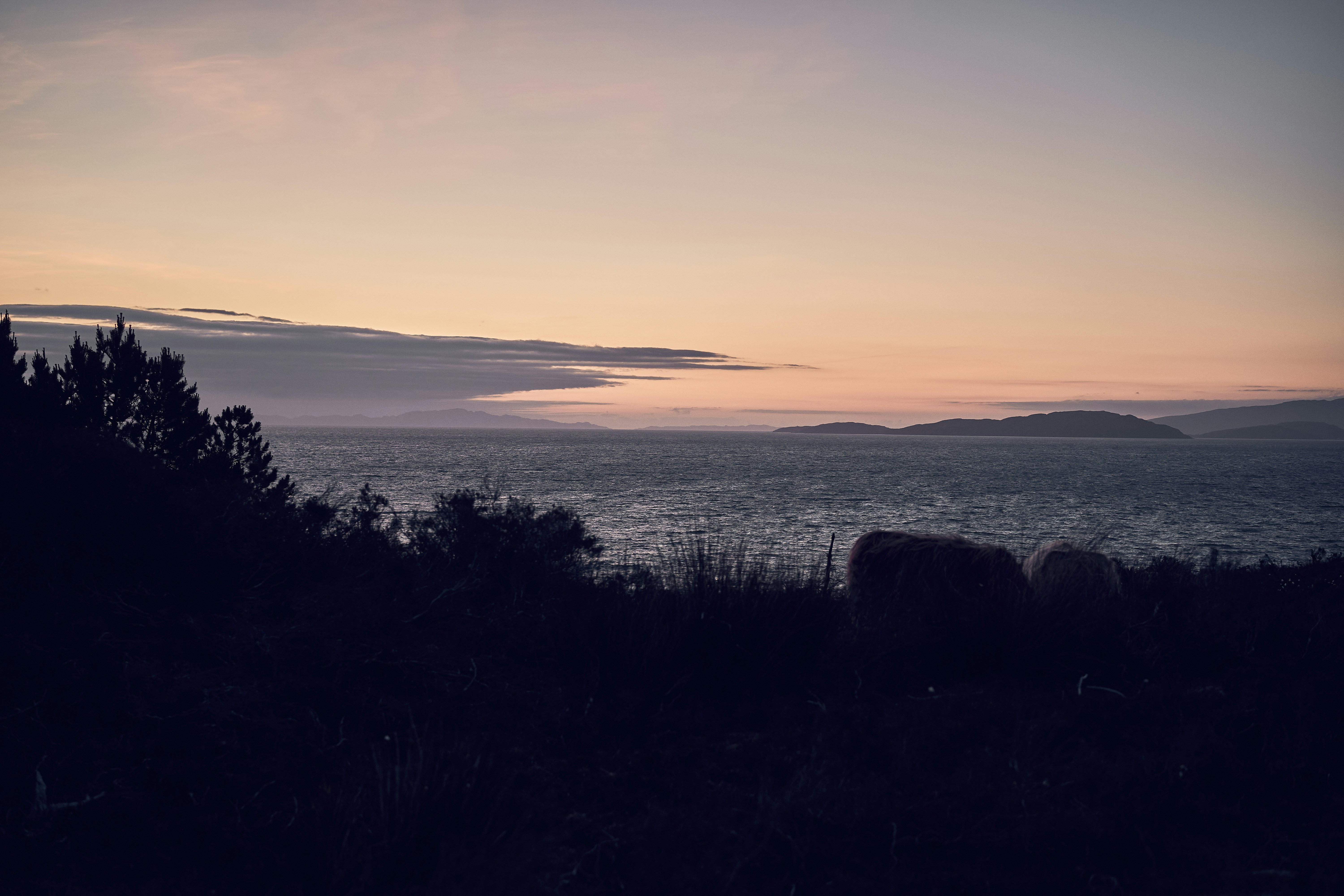 Evening light over the sea and hills of the Isle of Skye, Scotland.