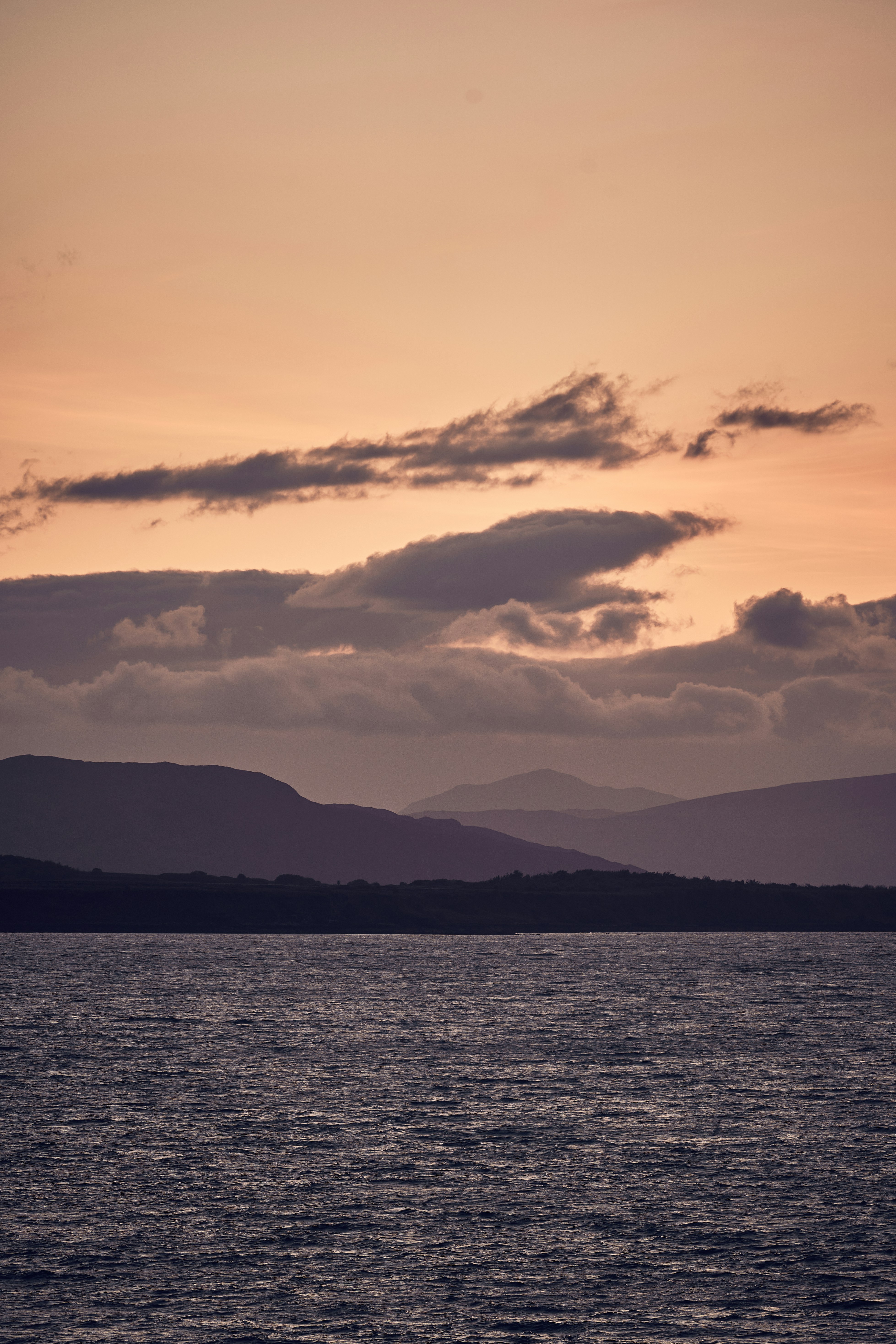 Evening light over the sea and hills of the Isle of Skye, Scotland.