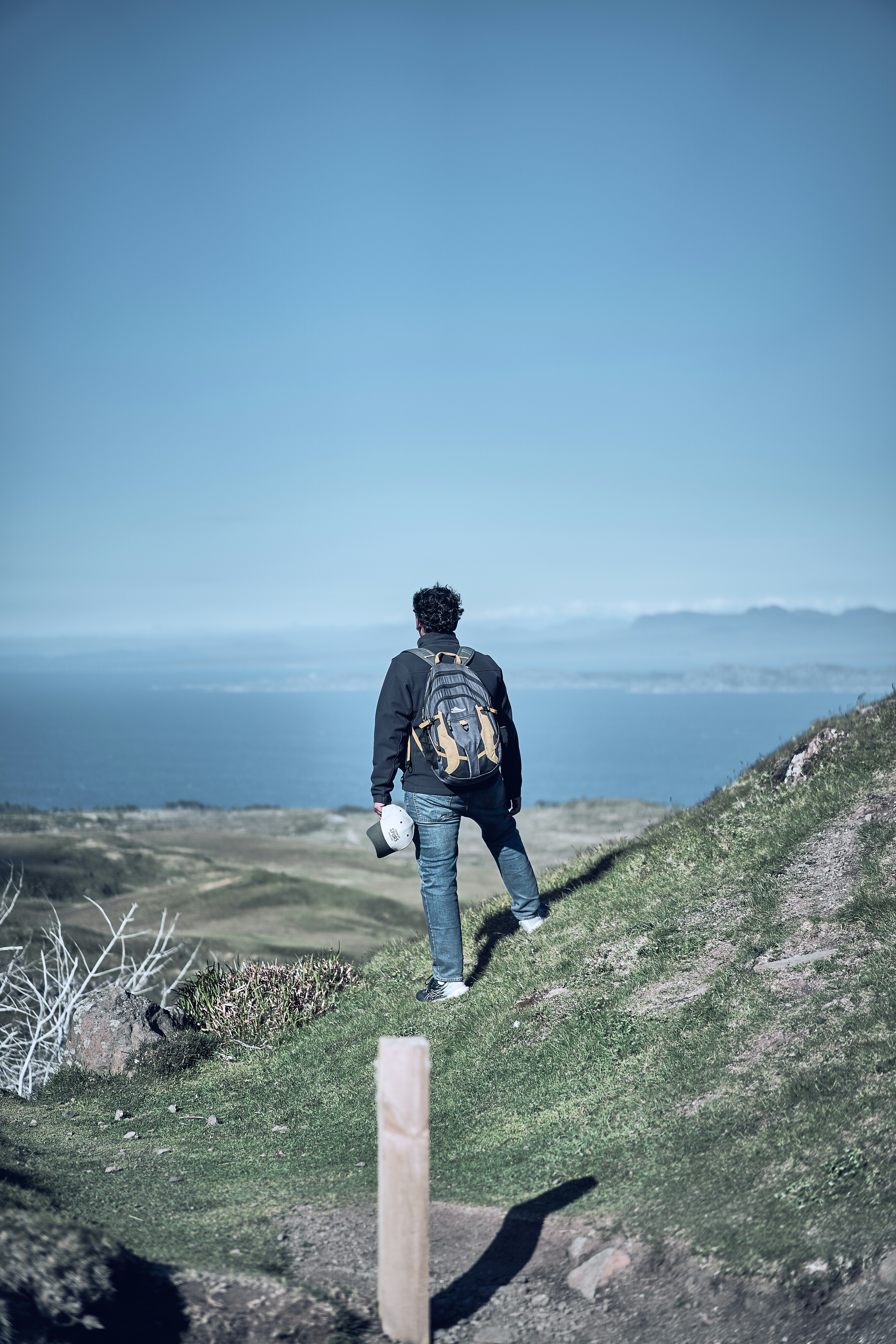 A hiker descending the Old Man of Storr trail on the Isle of Skye.