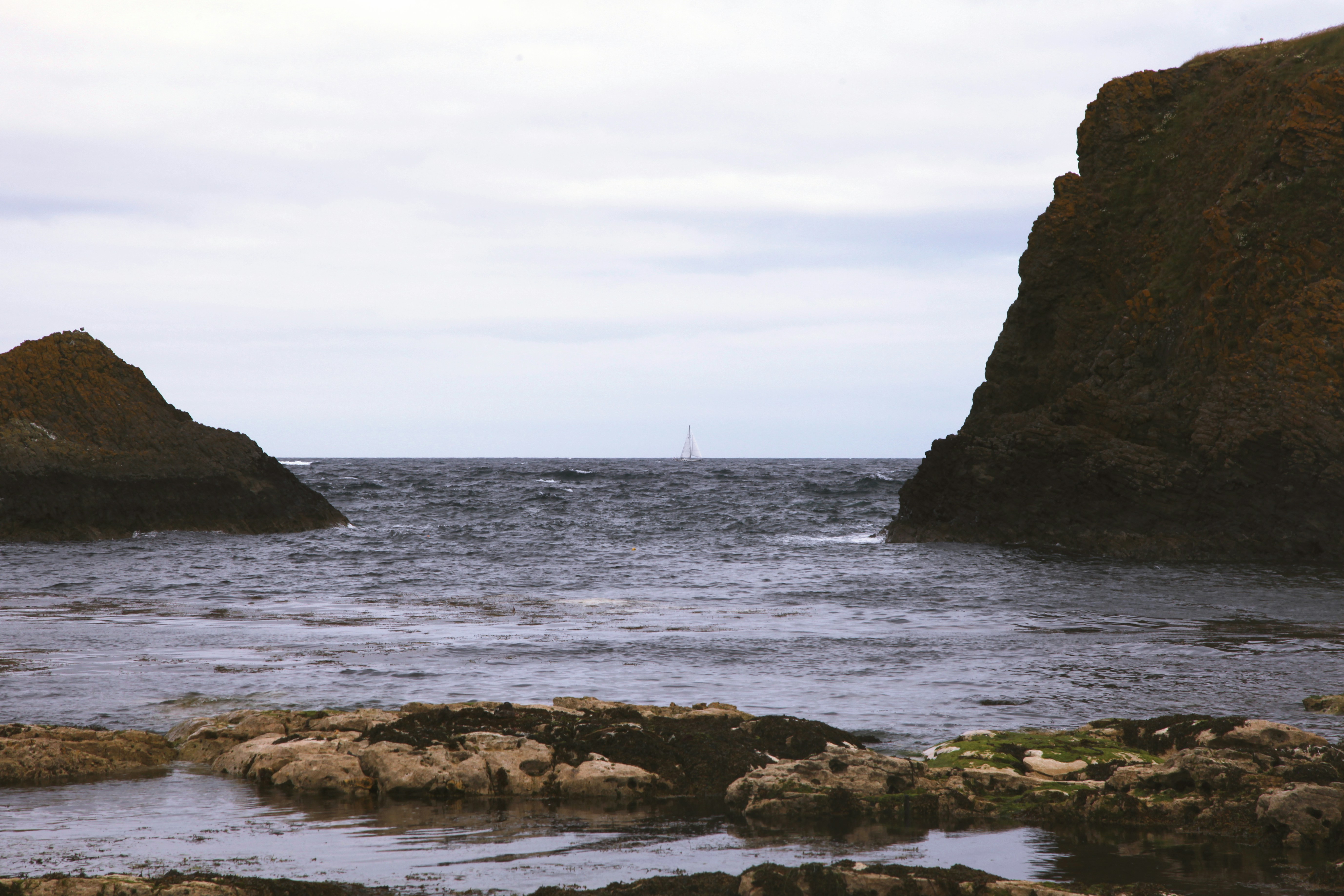 Sailboat between rocky cliffs - Free Photo on Unsplash