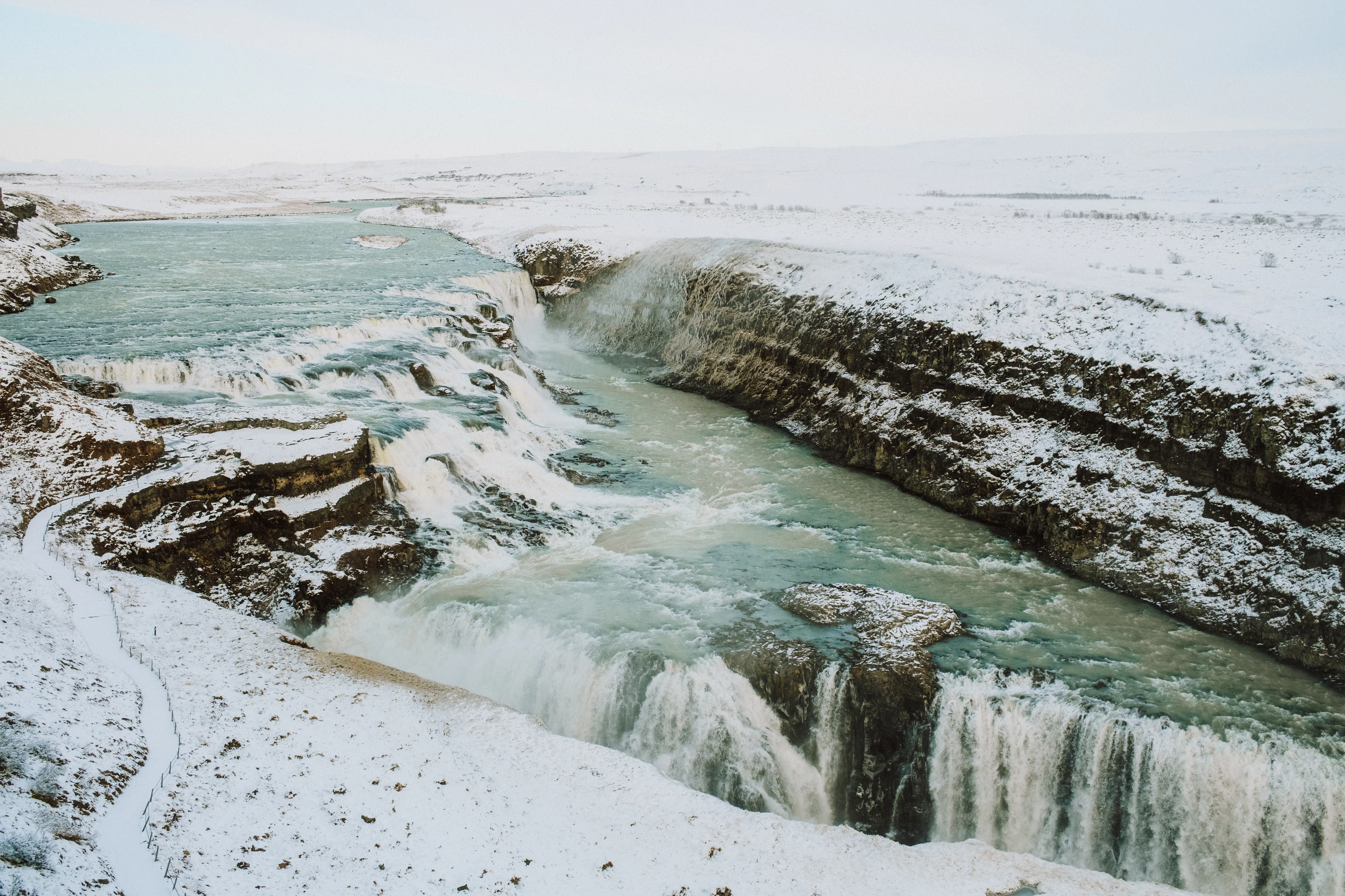 Gullfoss pouring into a snow-covered rocky canyon