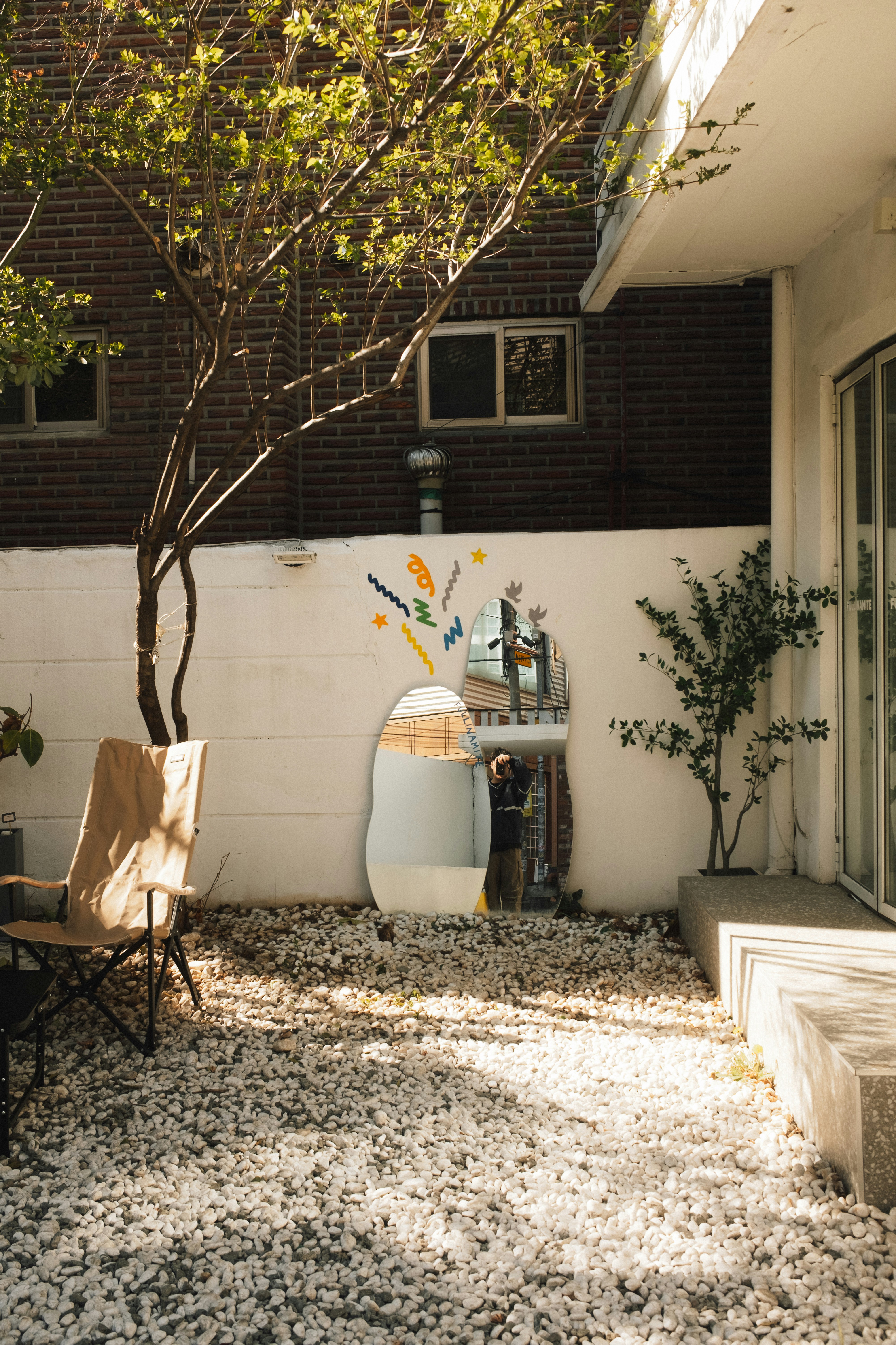 A white courtyard wall in daylight