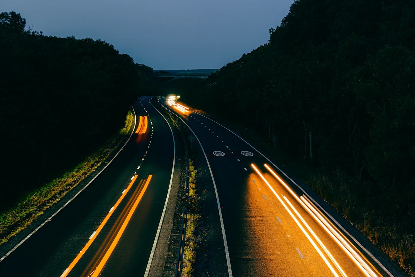 Long exposure light trails from traffic on a motorway at dusk