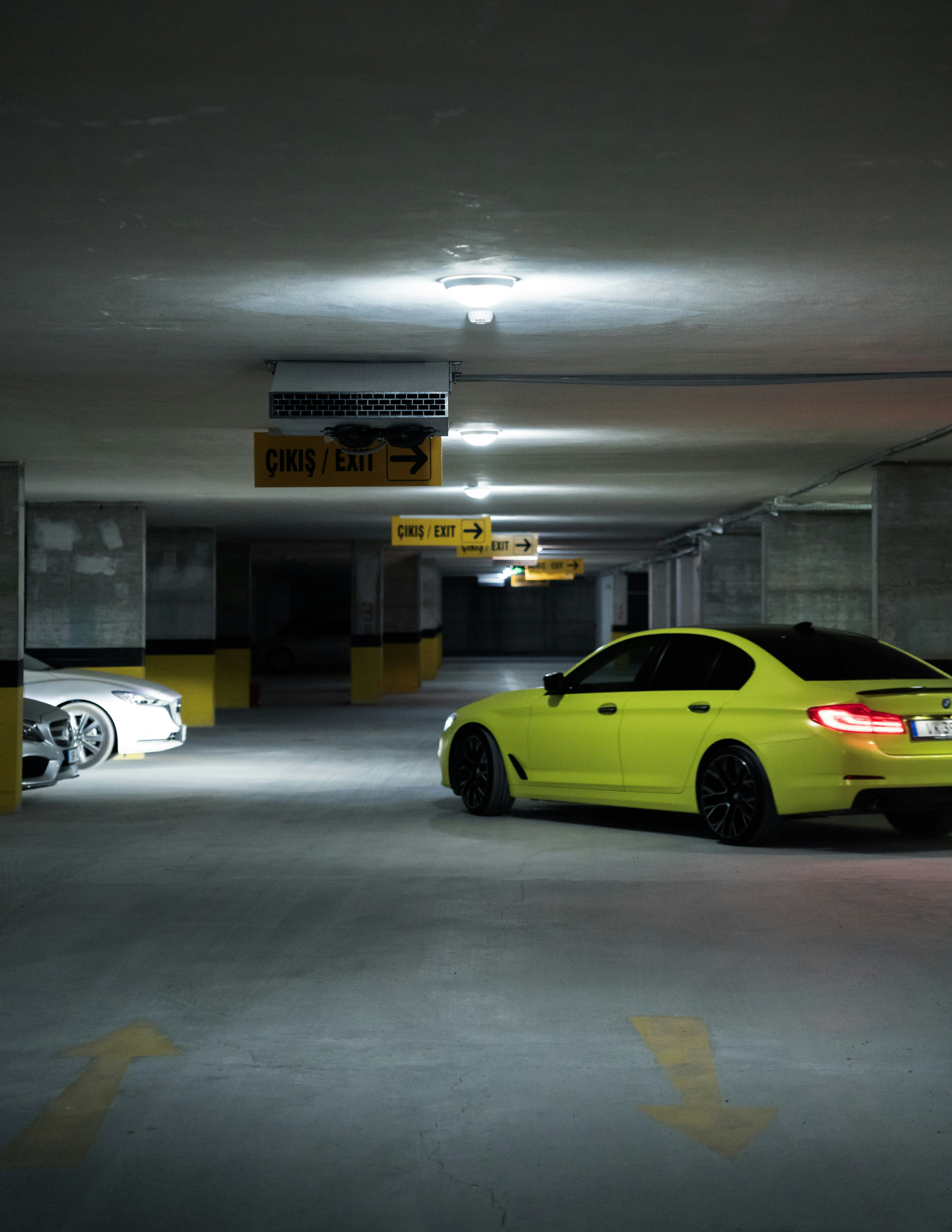Yellow sedan in underground parking garage - Free Photo on Unsplash