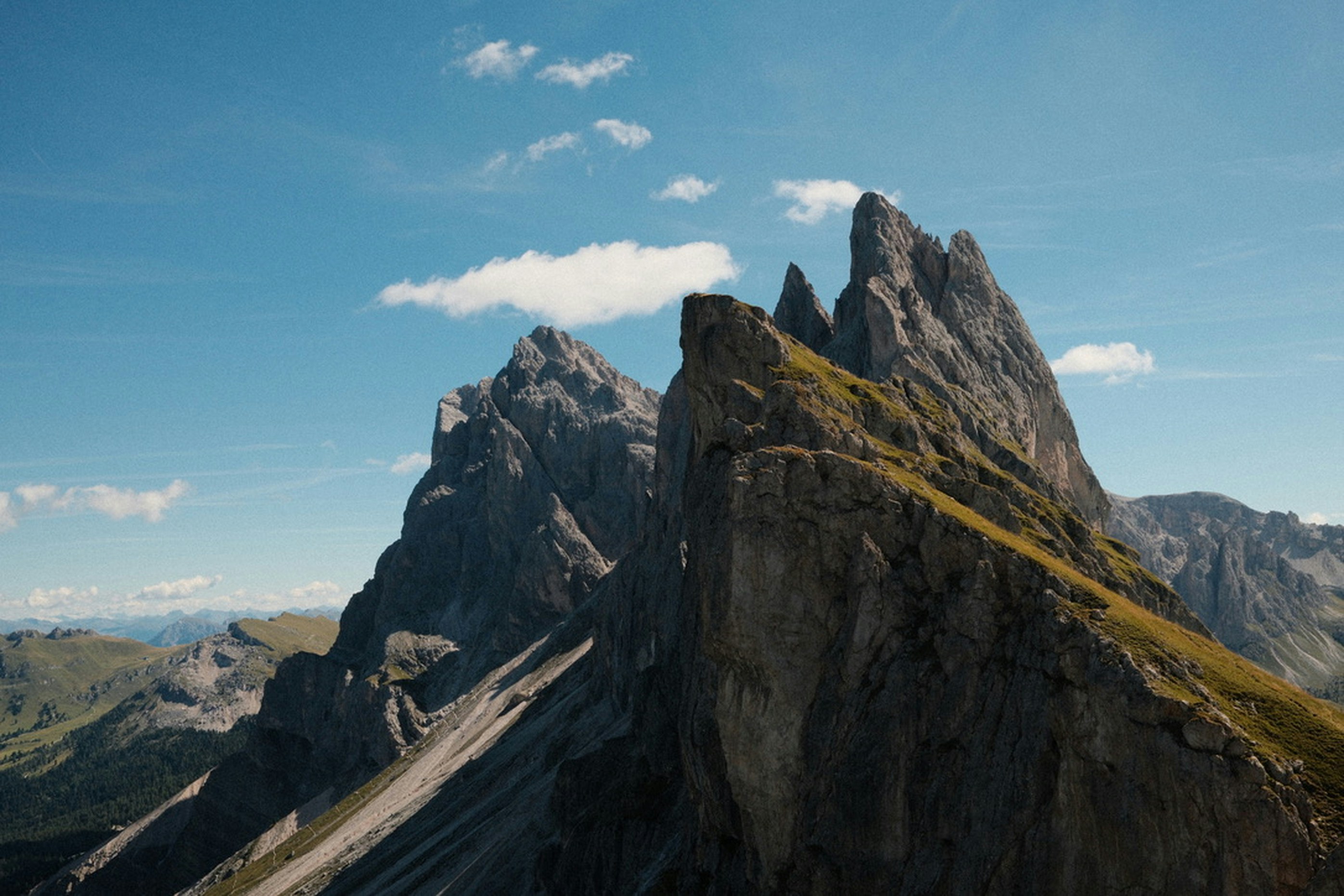 Jagged rocky peaks of the Seceda ridgeline under a clear blue sky