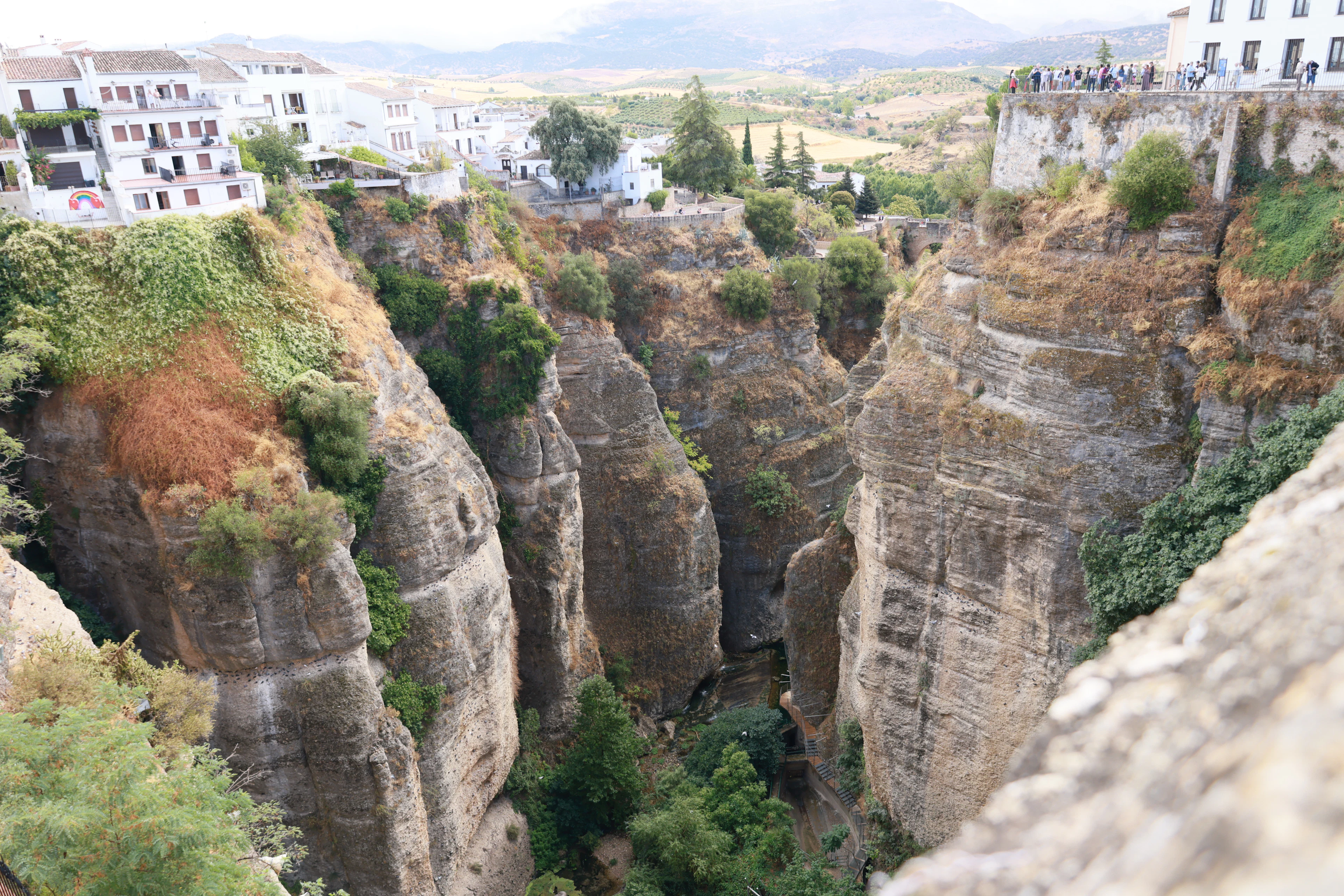White buildings of Ronda perched on the edge of its deep rocky gorge