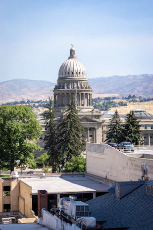 The Idaho State Capitol building with its dome against a backdrop of dry hills
