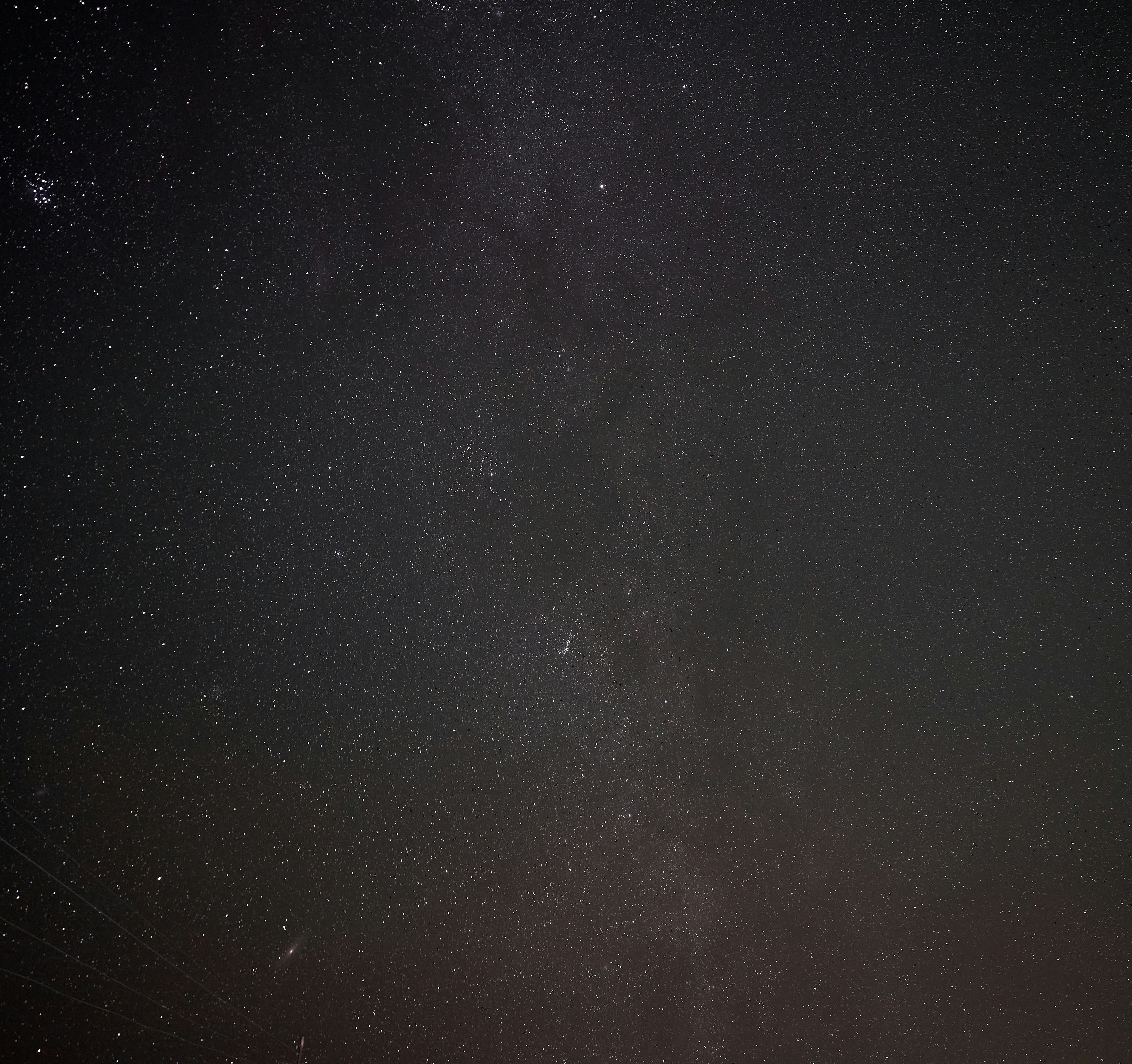 A vast night sky filled with countless bright stars and distant galaxies