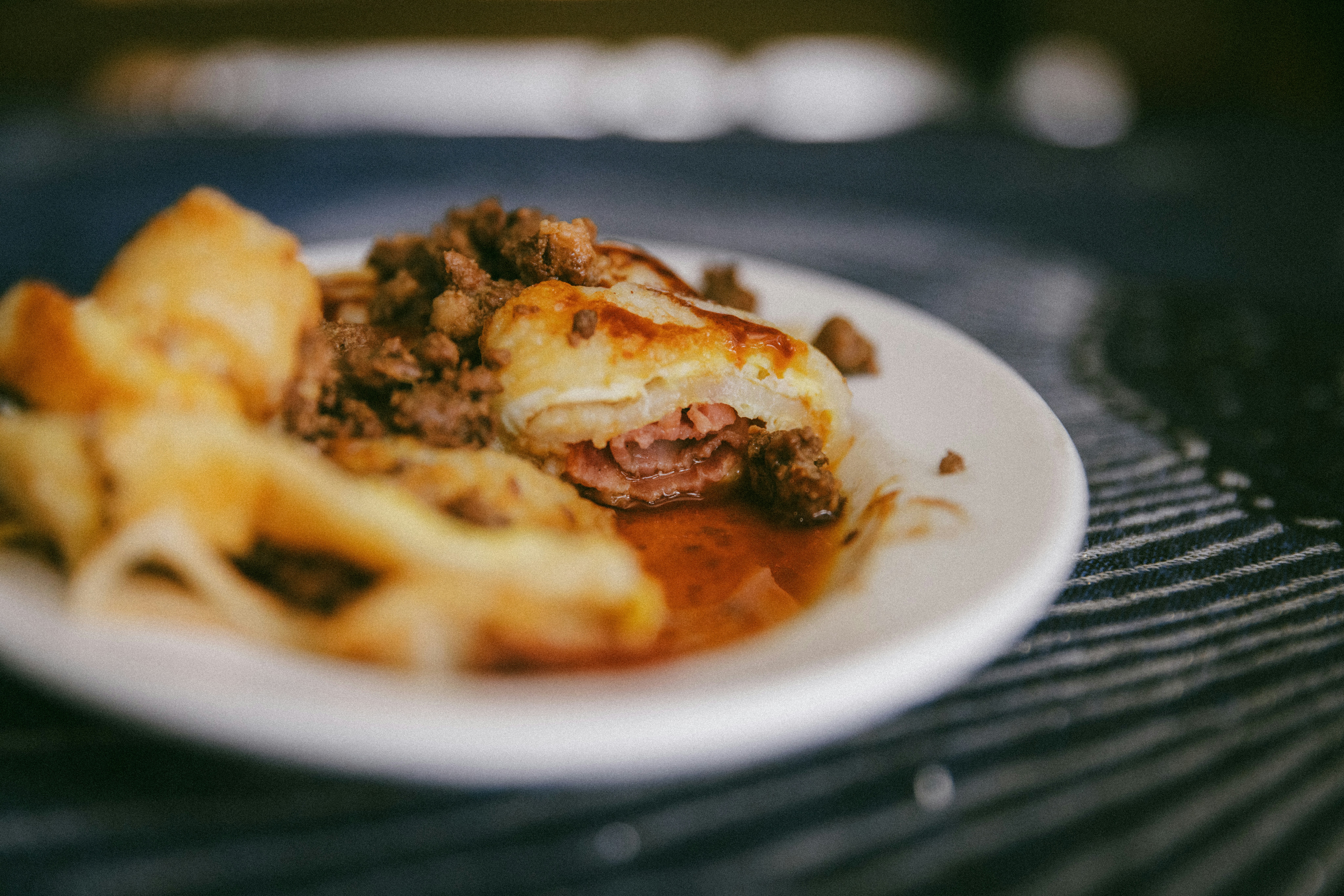 A savory pastry filled with meat on a white plate