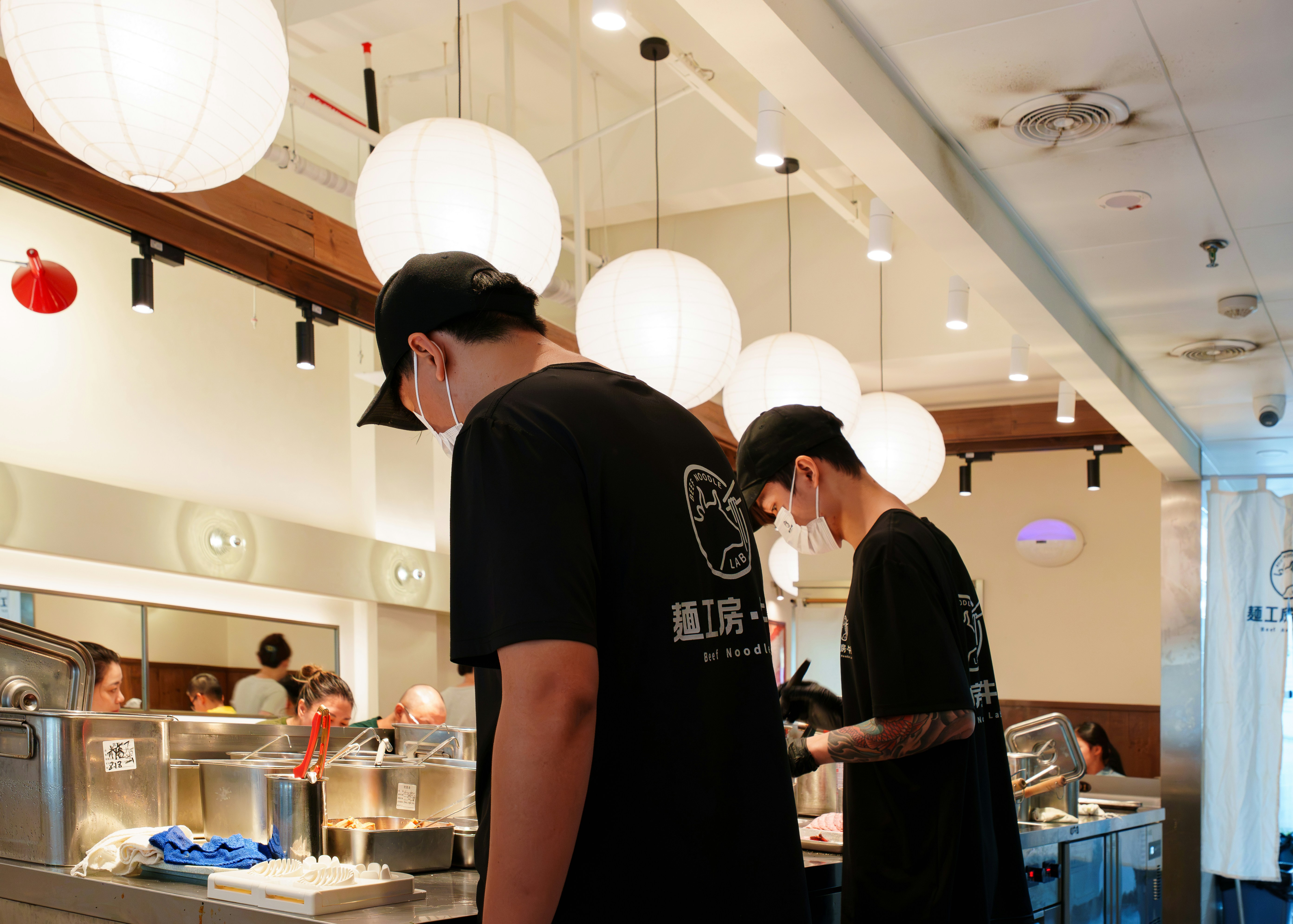 Two chefs in black t-shirts at work