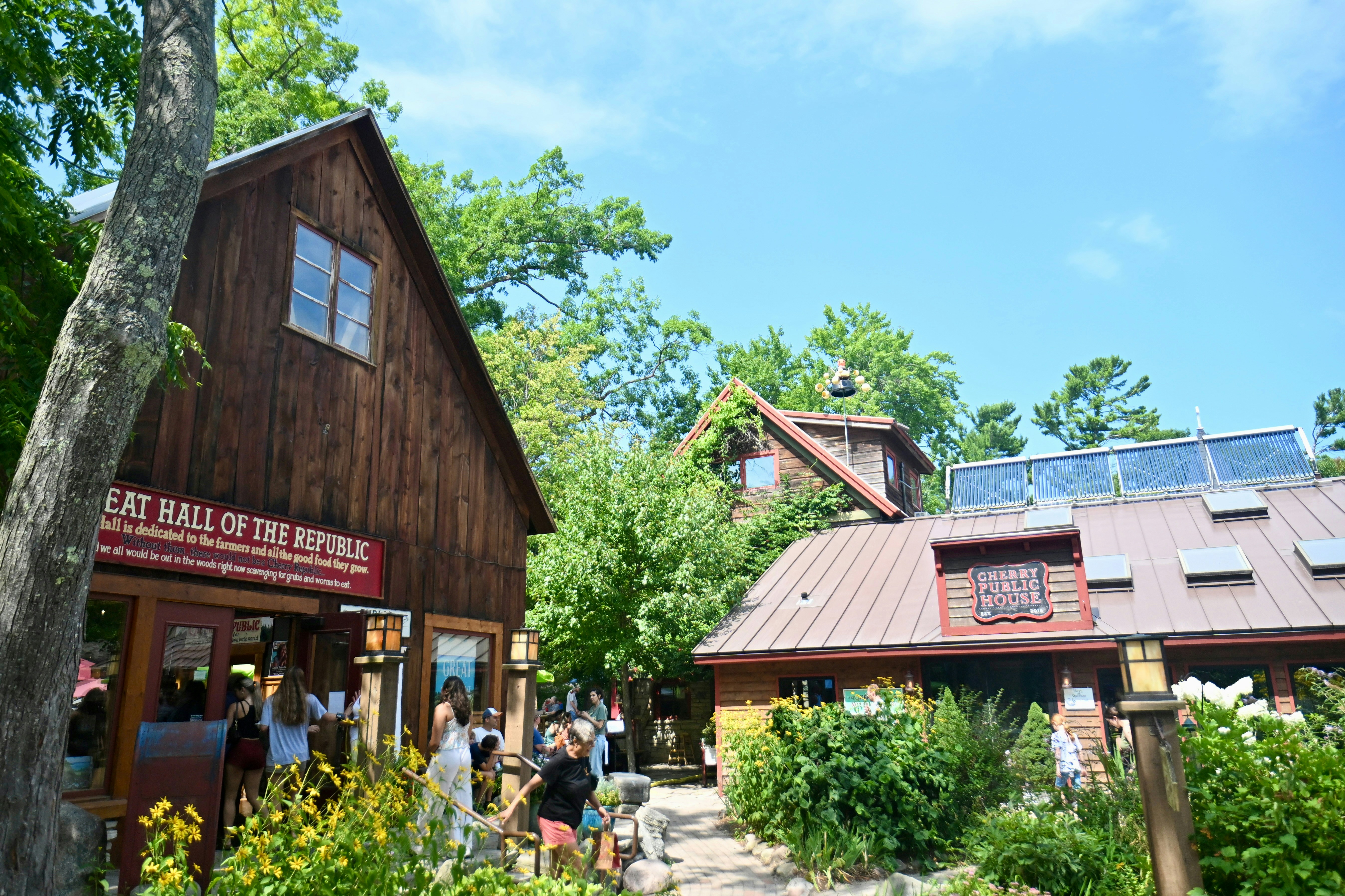 People entering wooden buildings labeled Great Hall of the Republic and Cherry Public House
