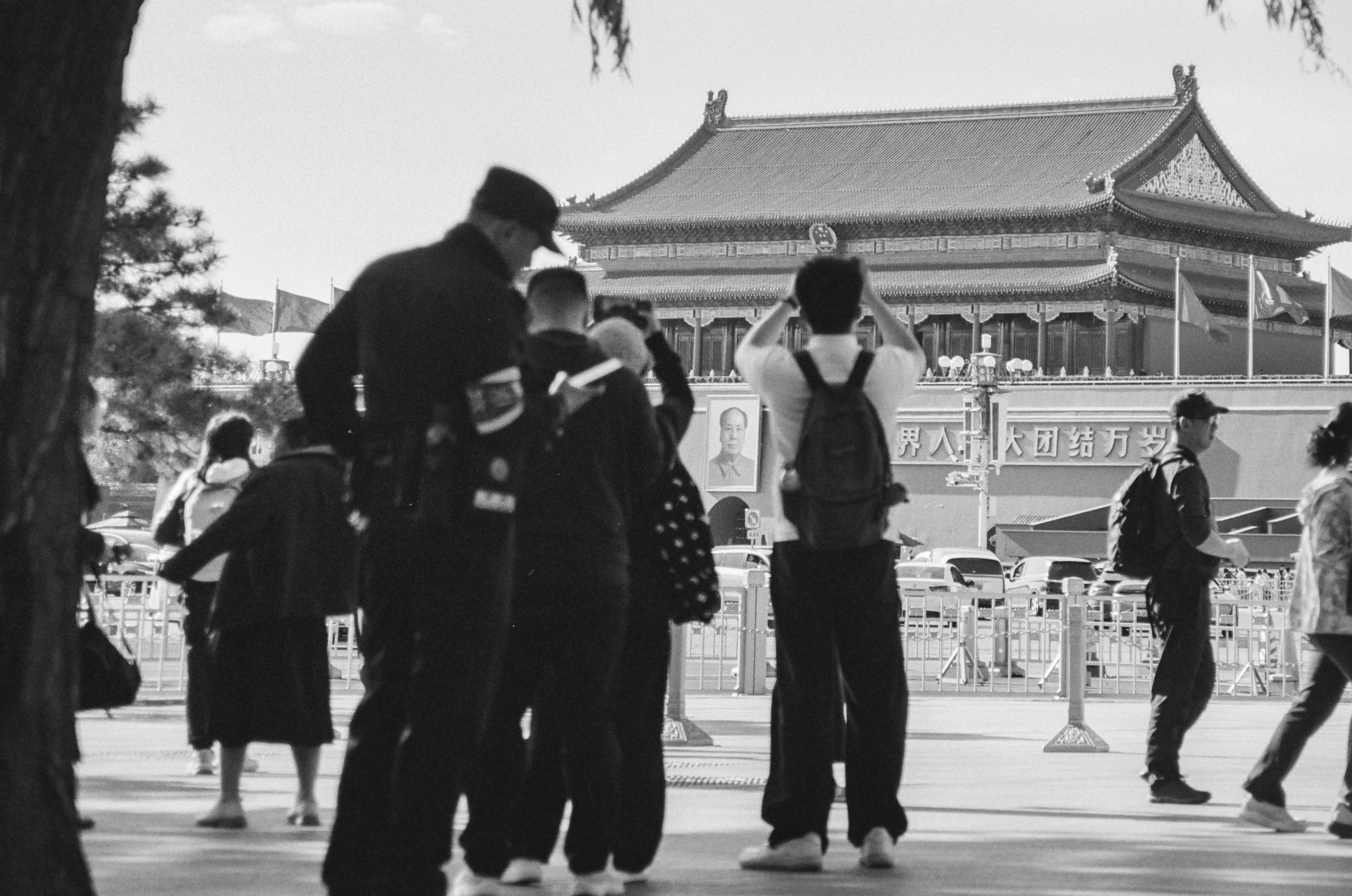 People in front of the Tiananmen Gate in Beijing with a portrait of Mao Zedong