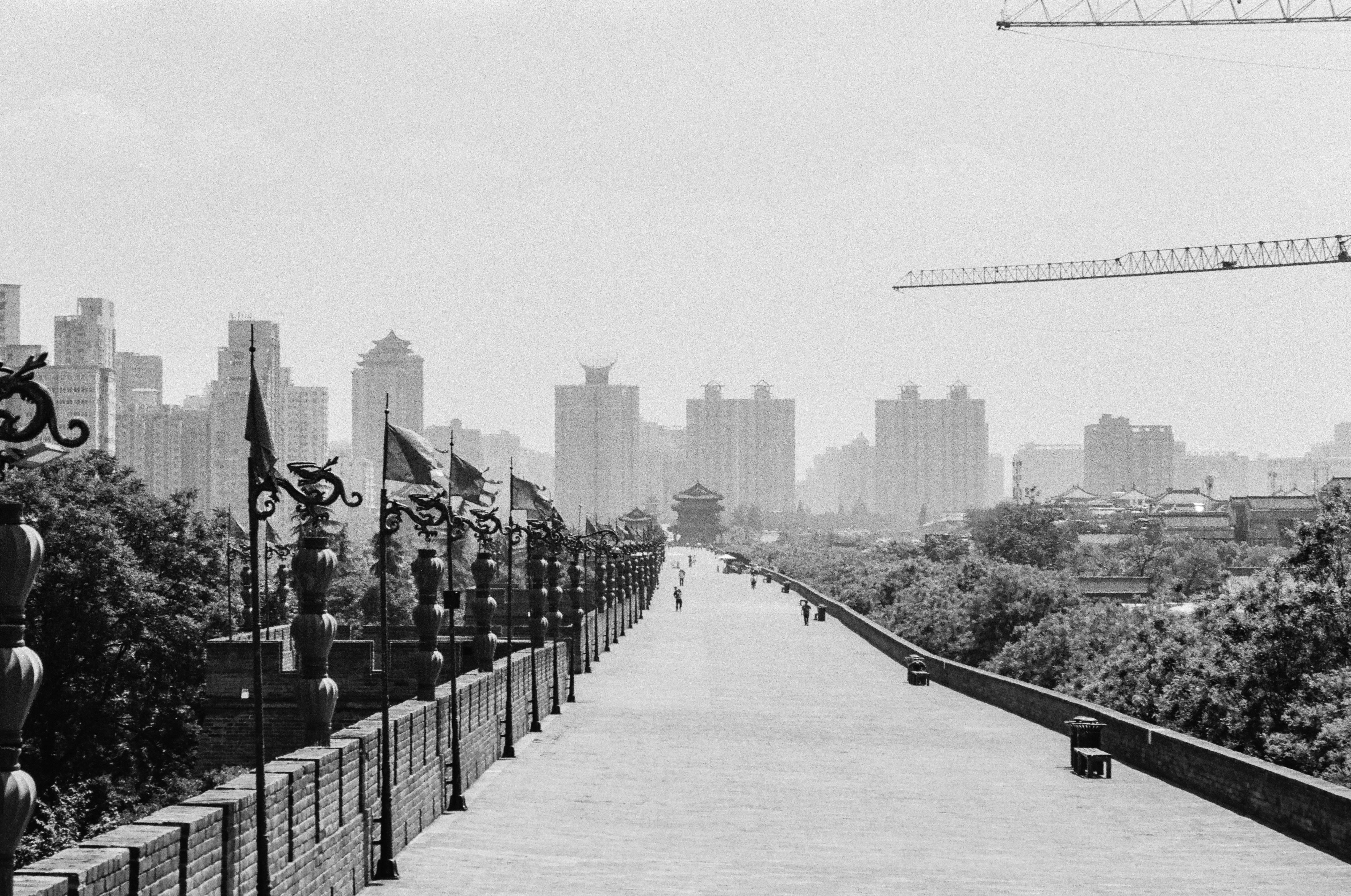 The ancient city wall of Xi'an with decorative lanterns and a modern skyline