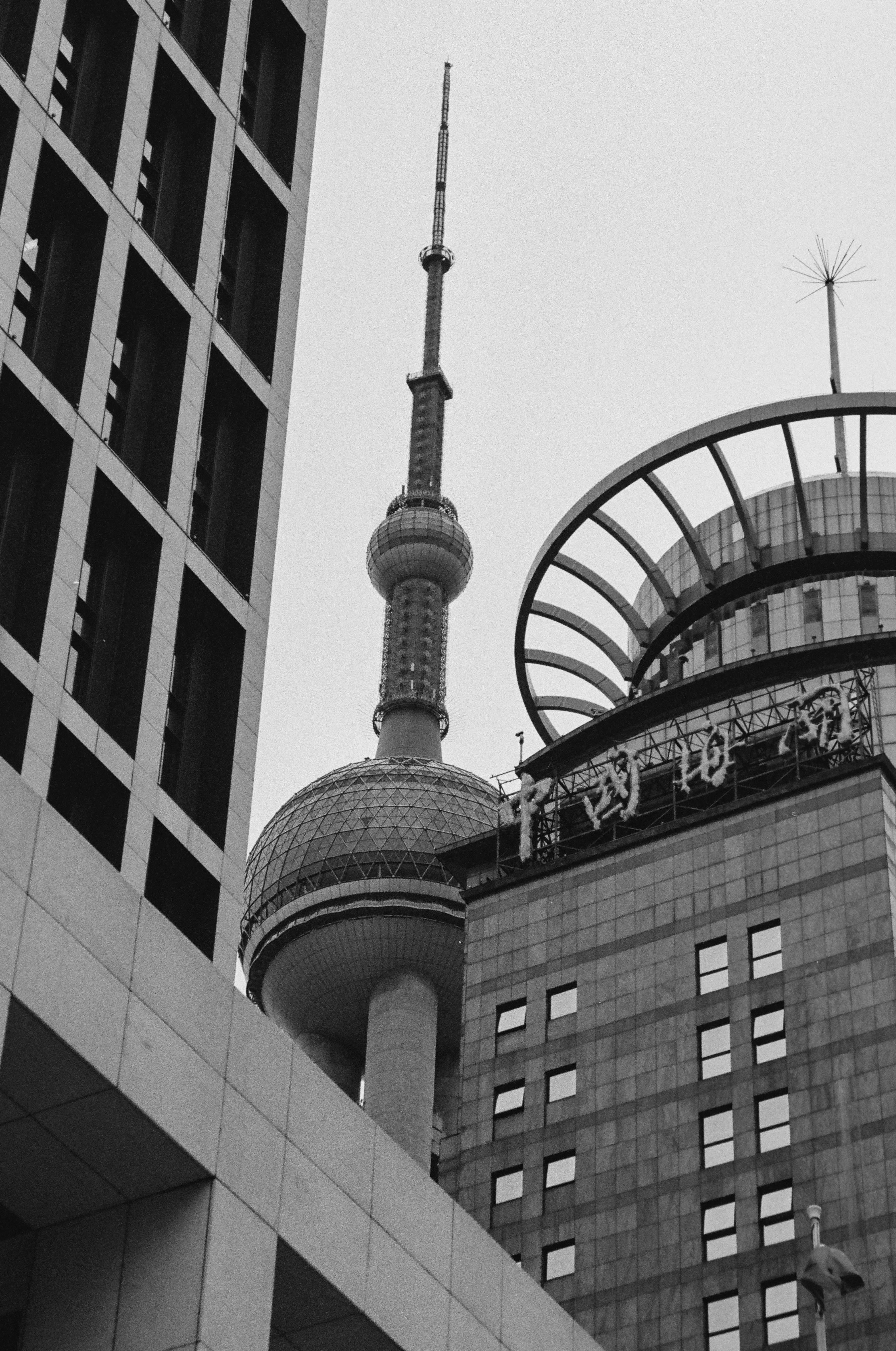 The Oriental Pearl Tower rising between modern skyscrapers in Shanghai