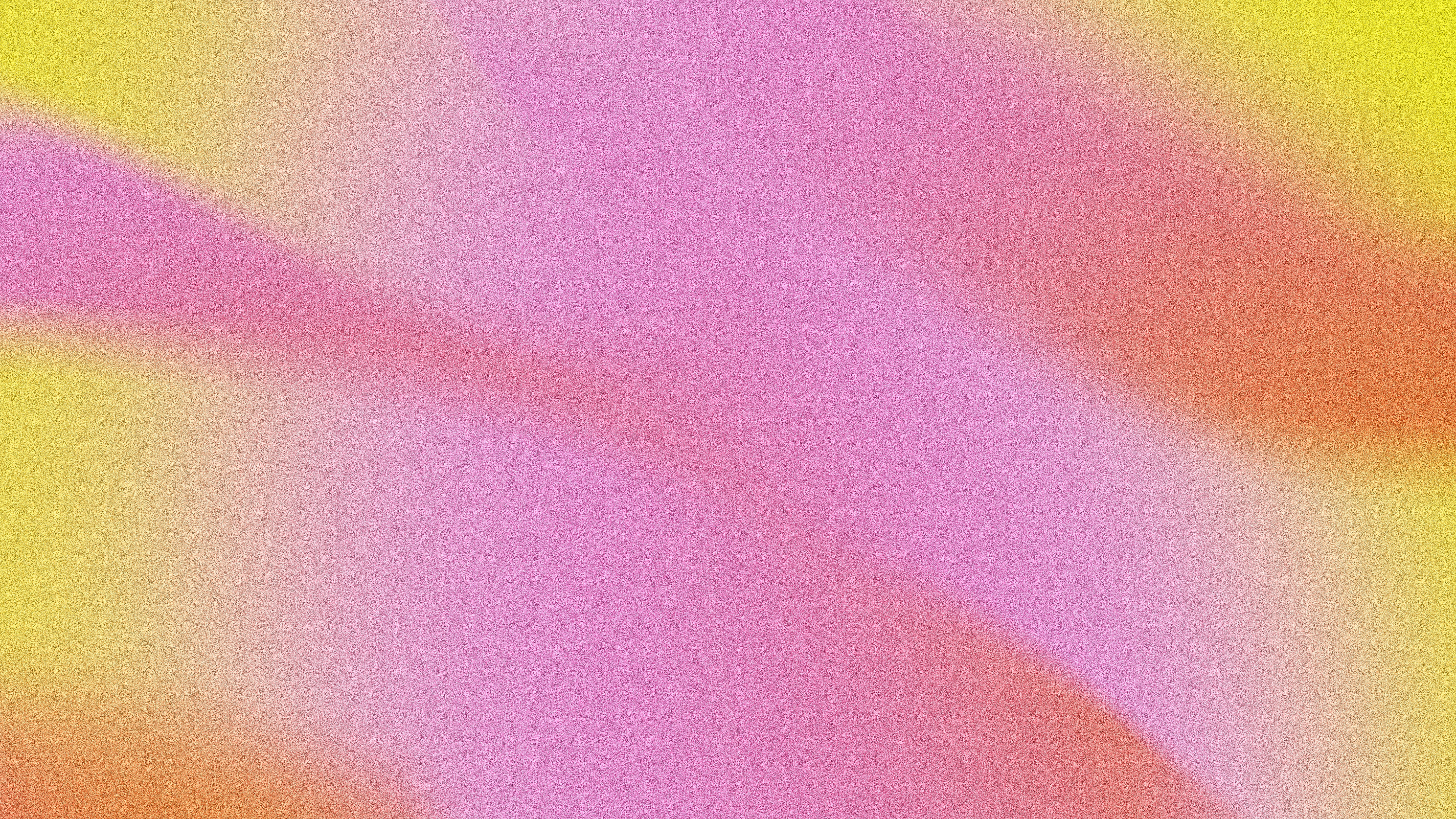 A soft gradient shifting from yellow to pink and orange with grainy texture