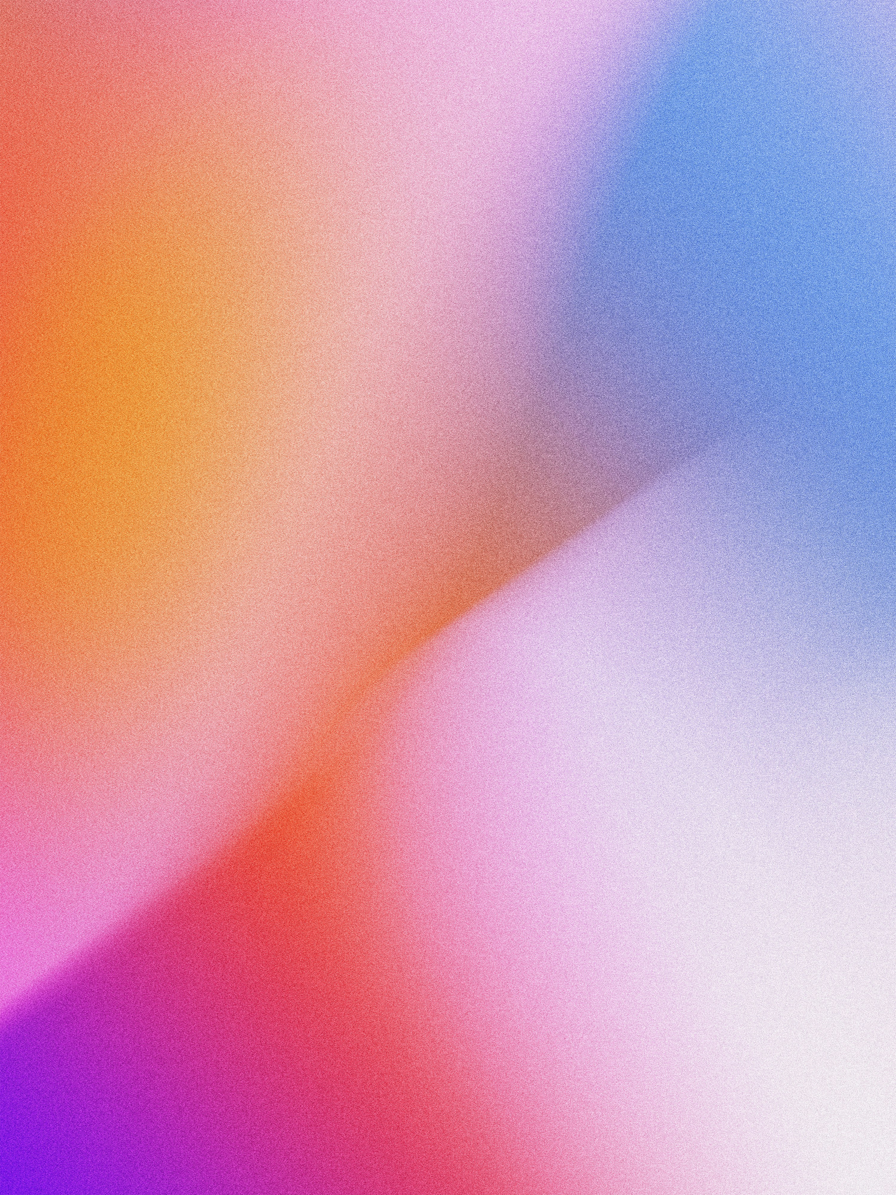 A soft gradient shifting from orange to pink and blue with grainy texture