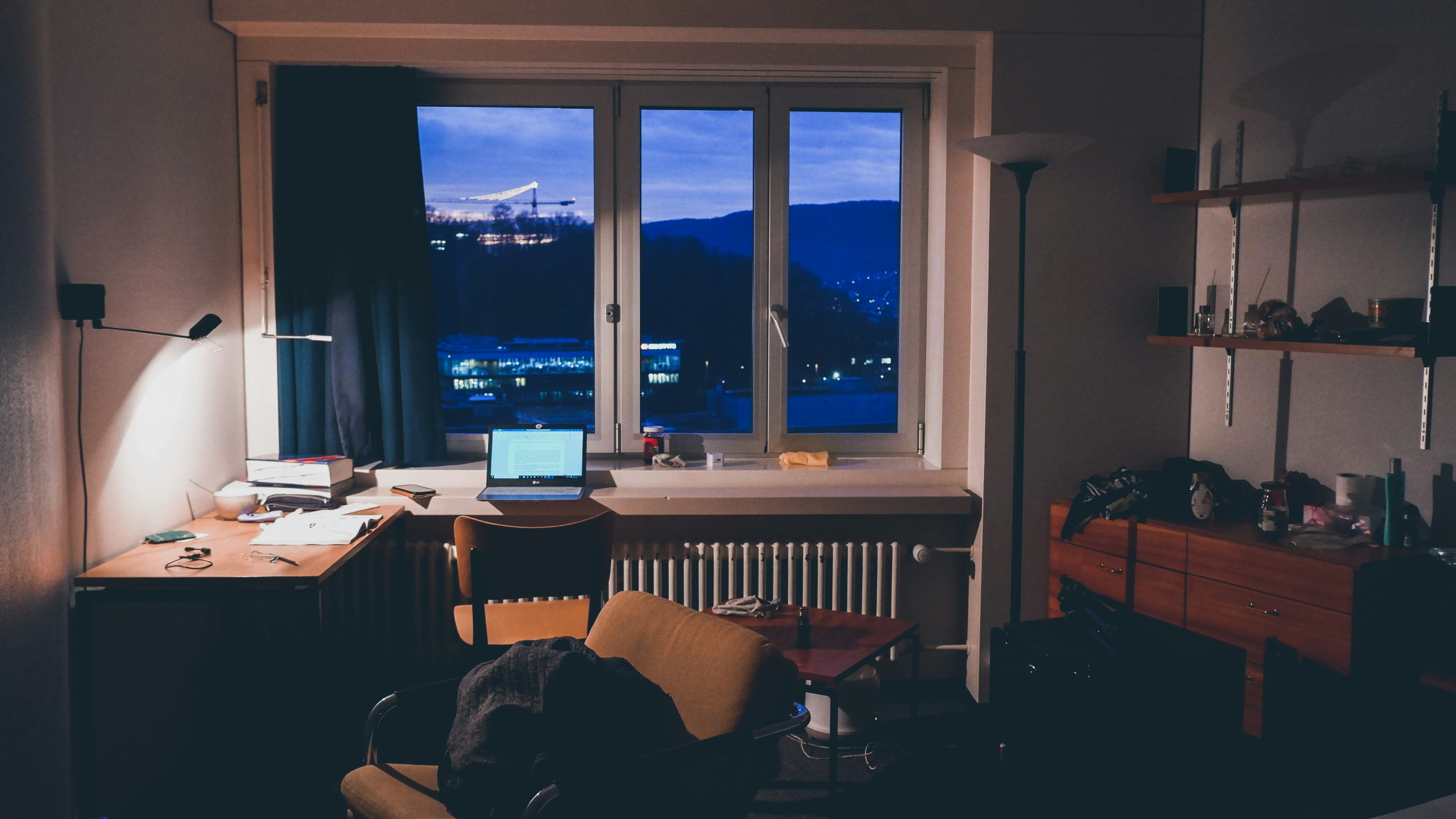 Laptop on a desk in a home office at night