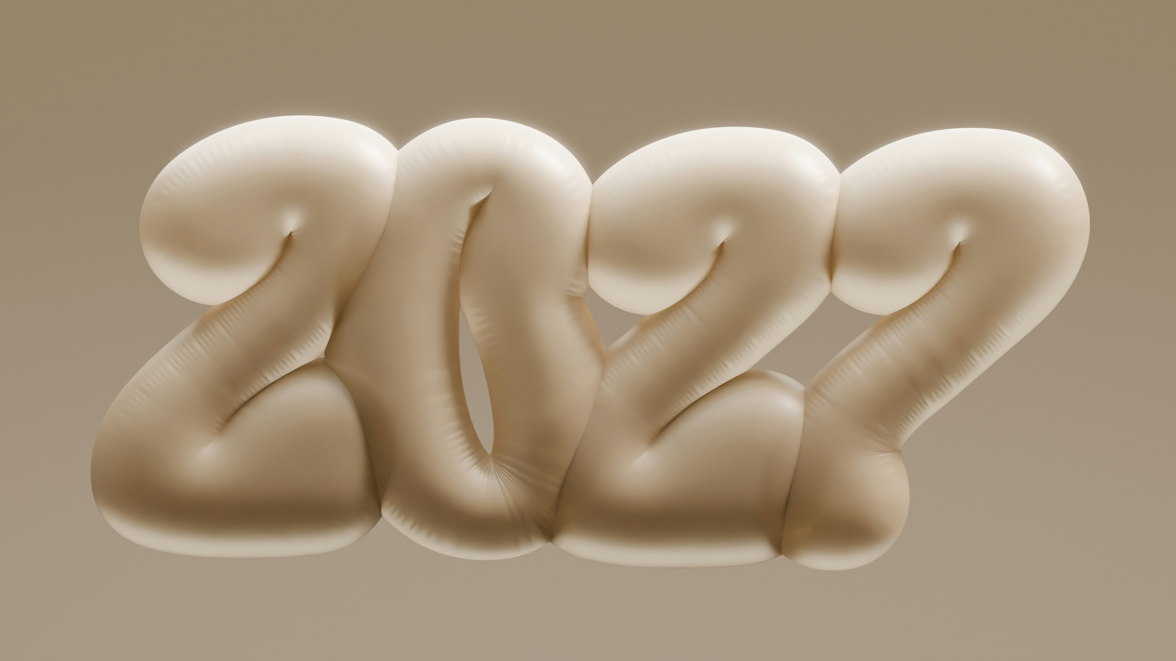Inflatable beige numbers forming 2022 against a matching solid background
