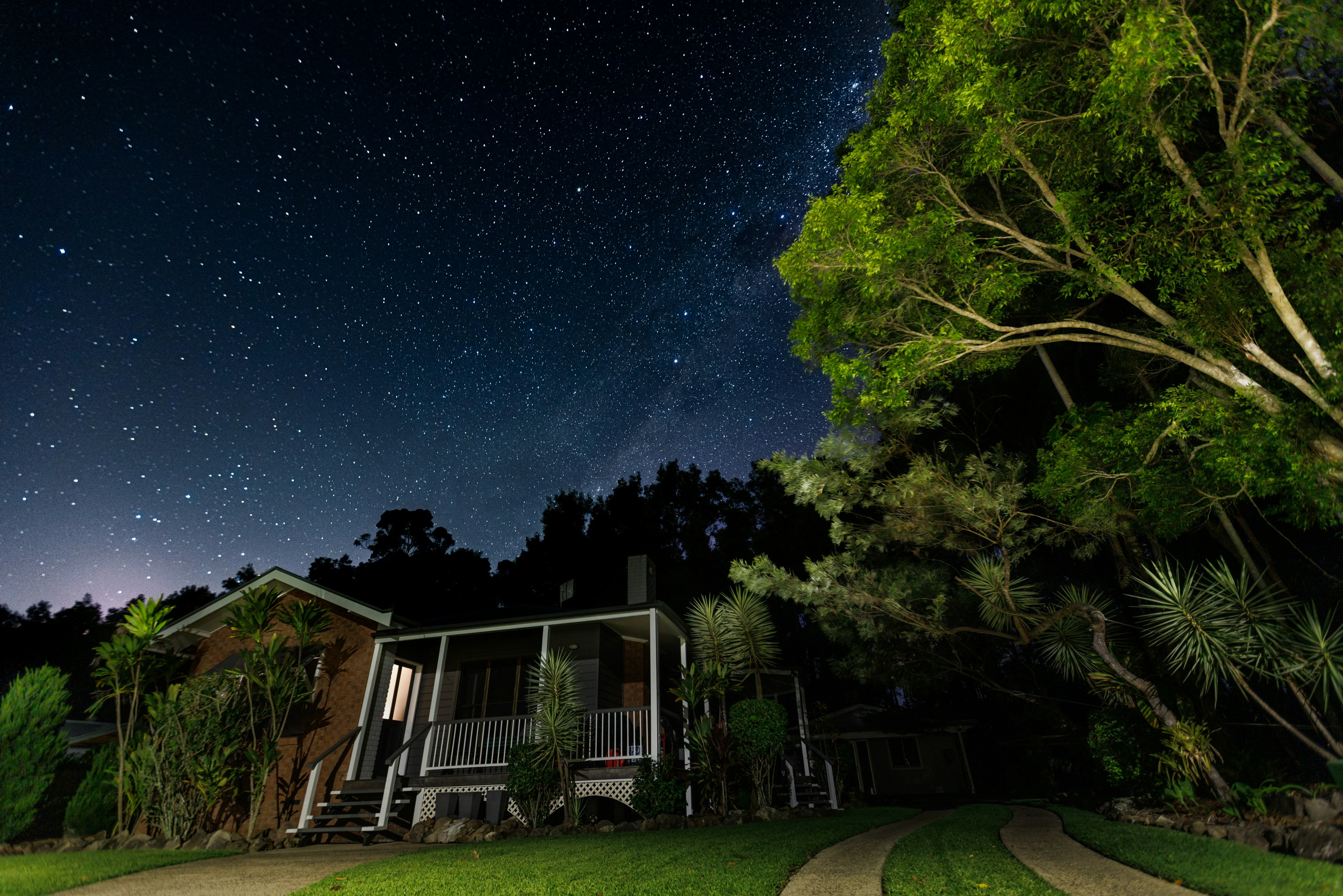 House with front porch under a starry night sky