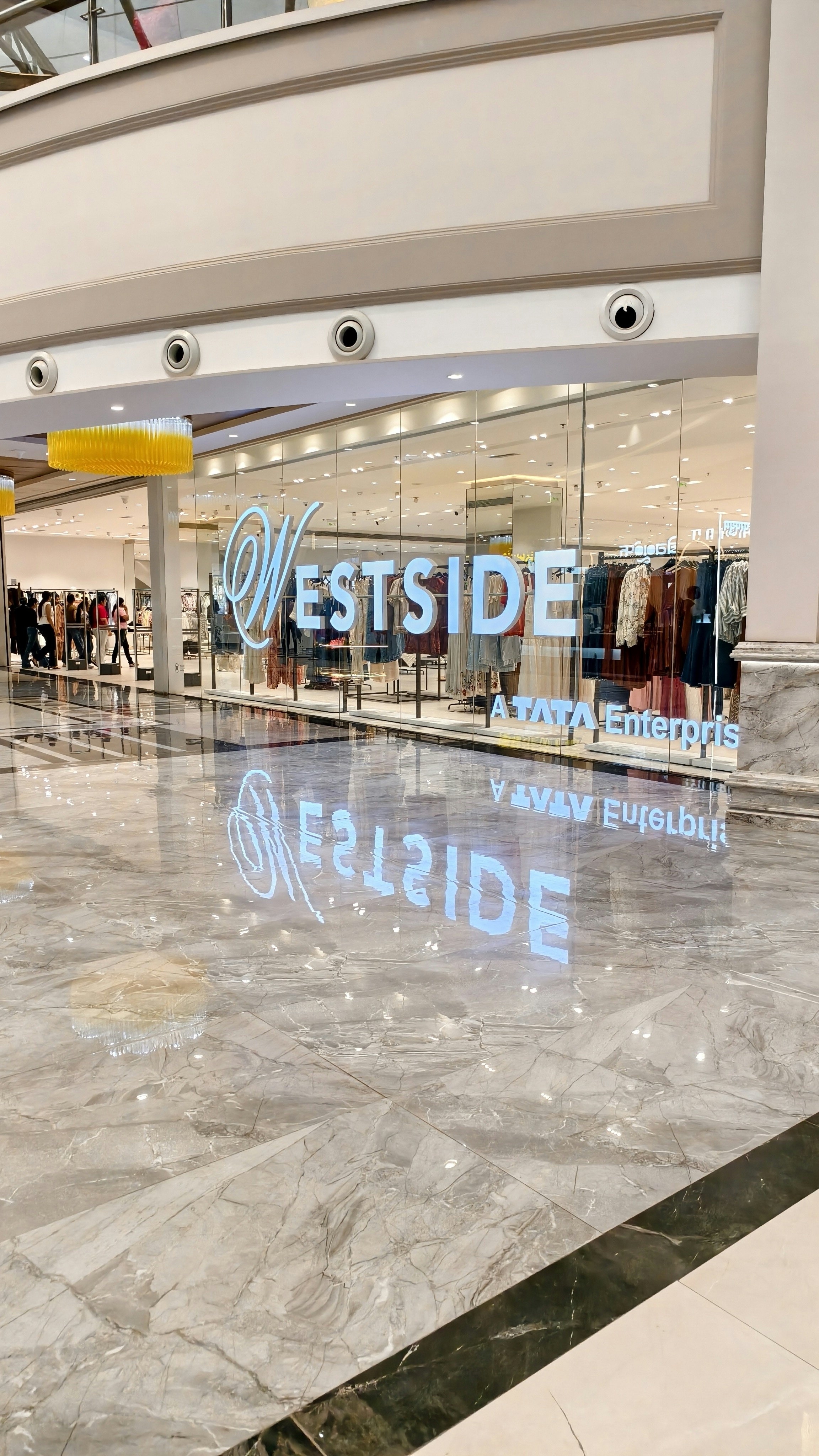 A Westside clothing store storefront with glass walls and a polished marble floor