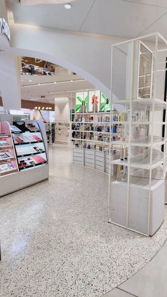 Cosmetic displays and shelves with beauty products in a bright retail store