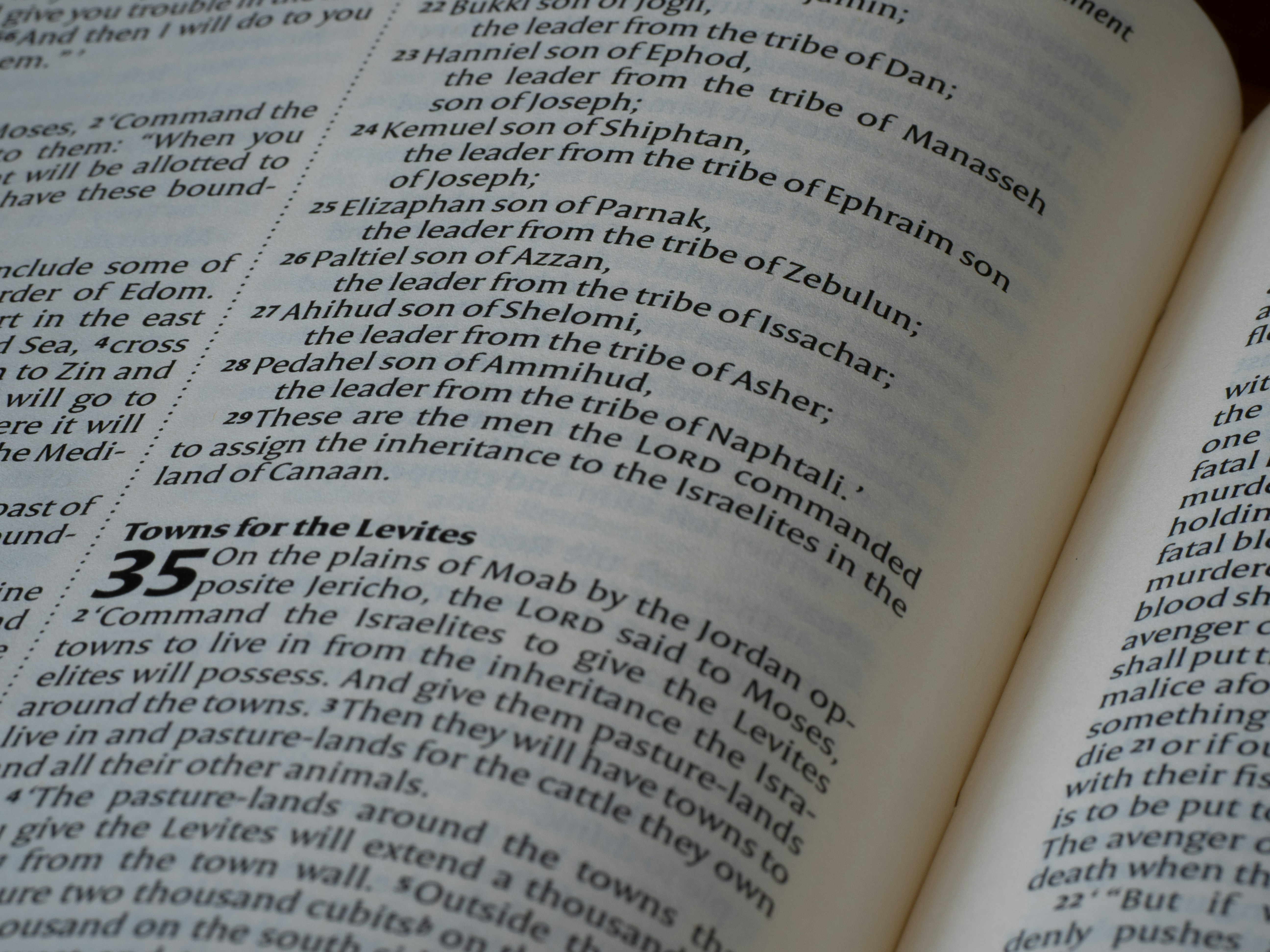 Close-up of printed text on an open page of a religious book