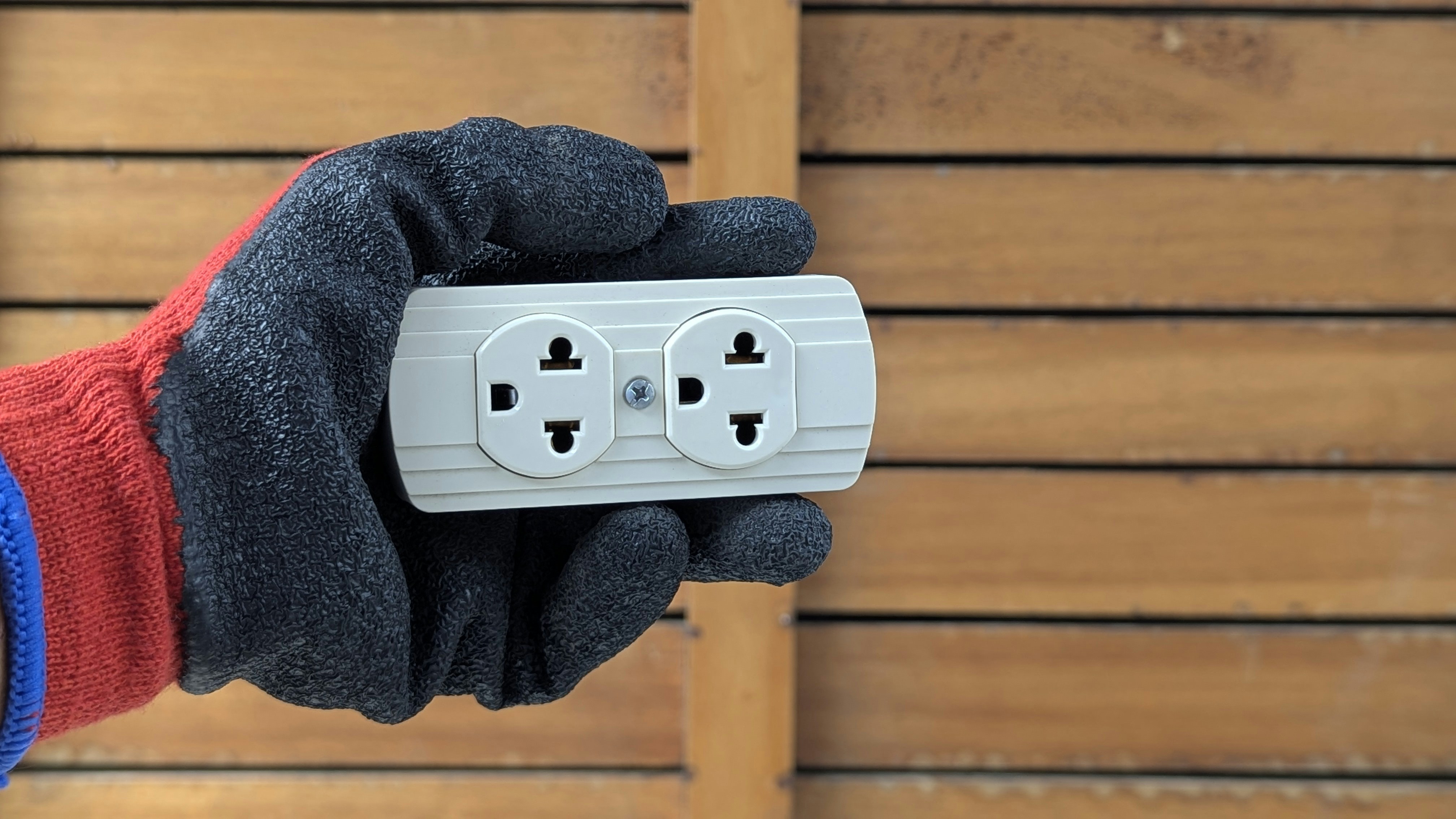 Electrician installing electrical outlet