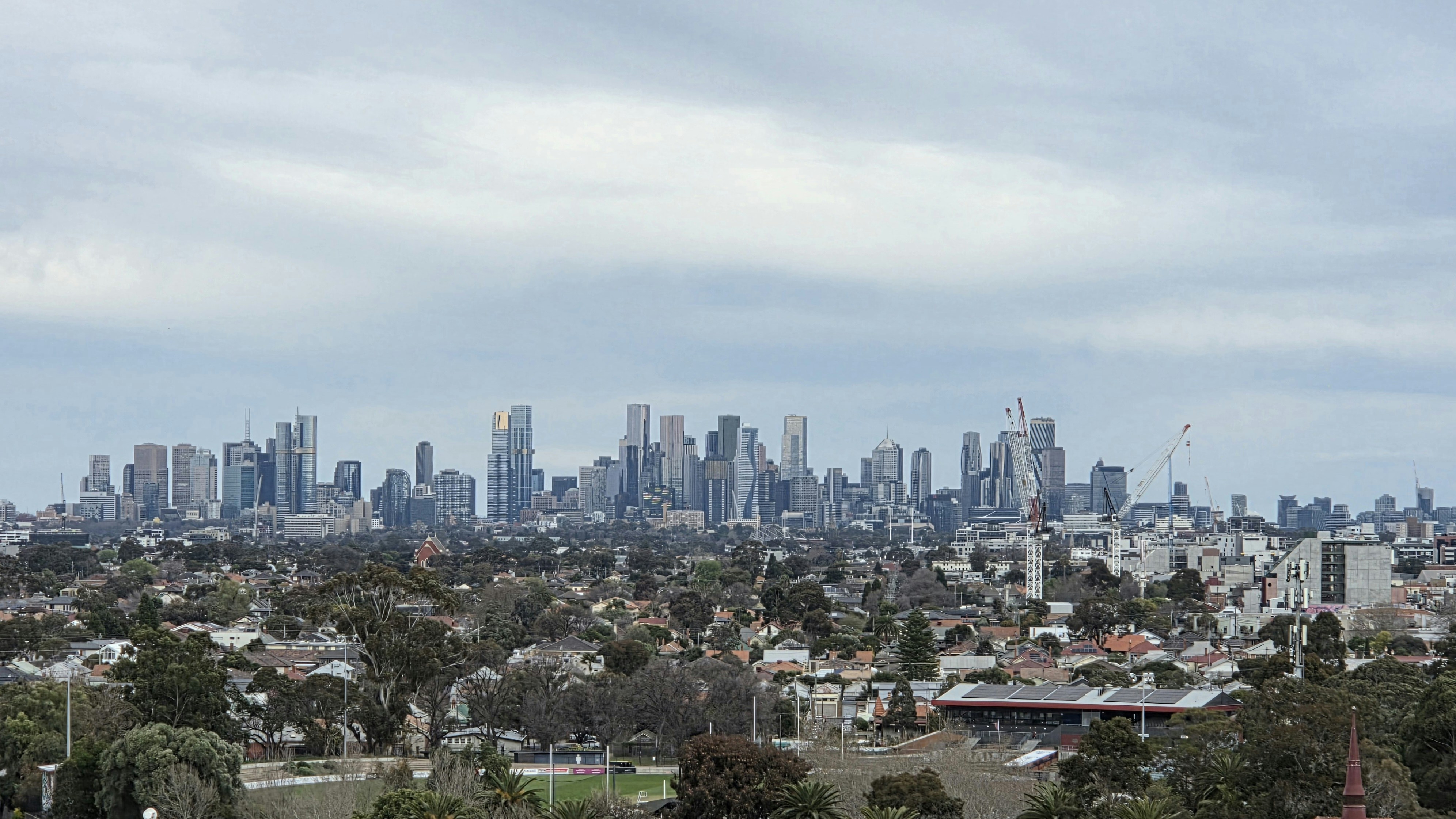 Suburban rooftops with the city skyline beyond