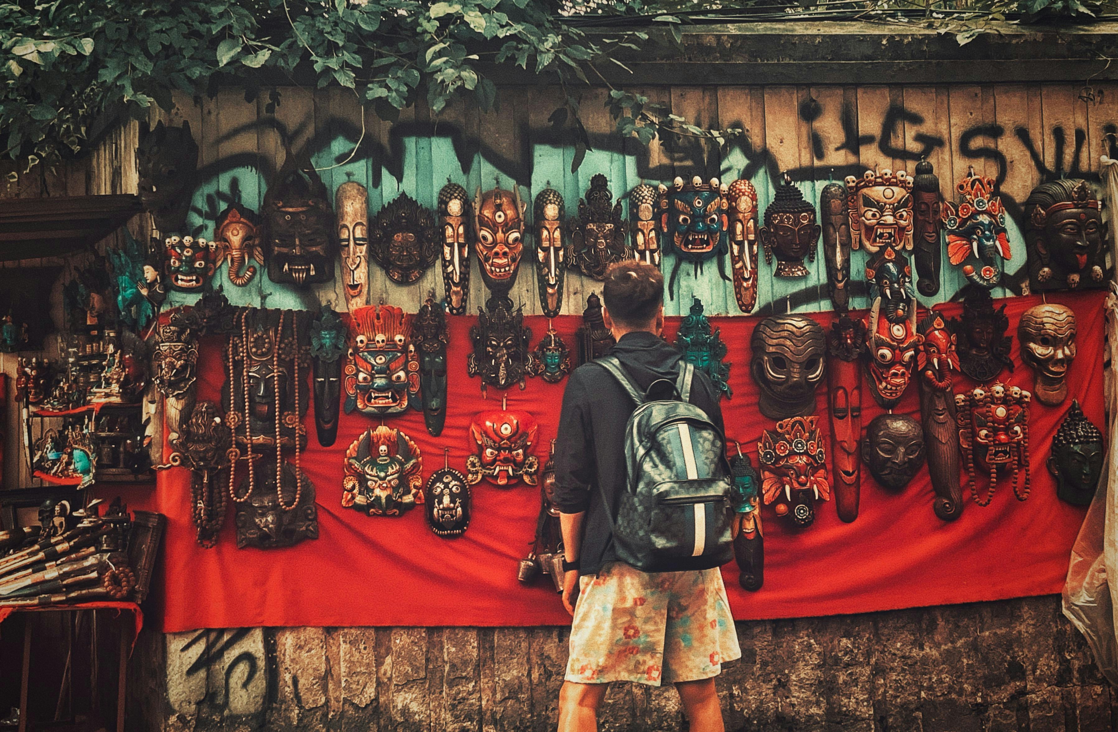 Person with a backpack looking at a mask stall
