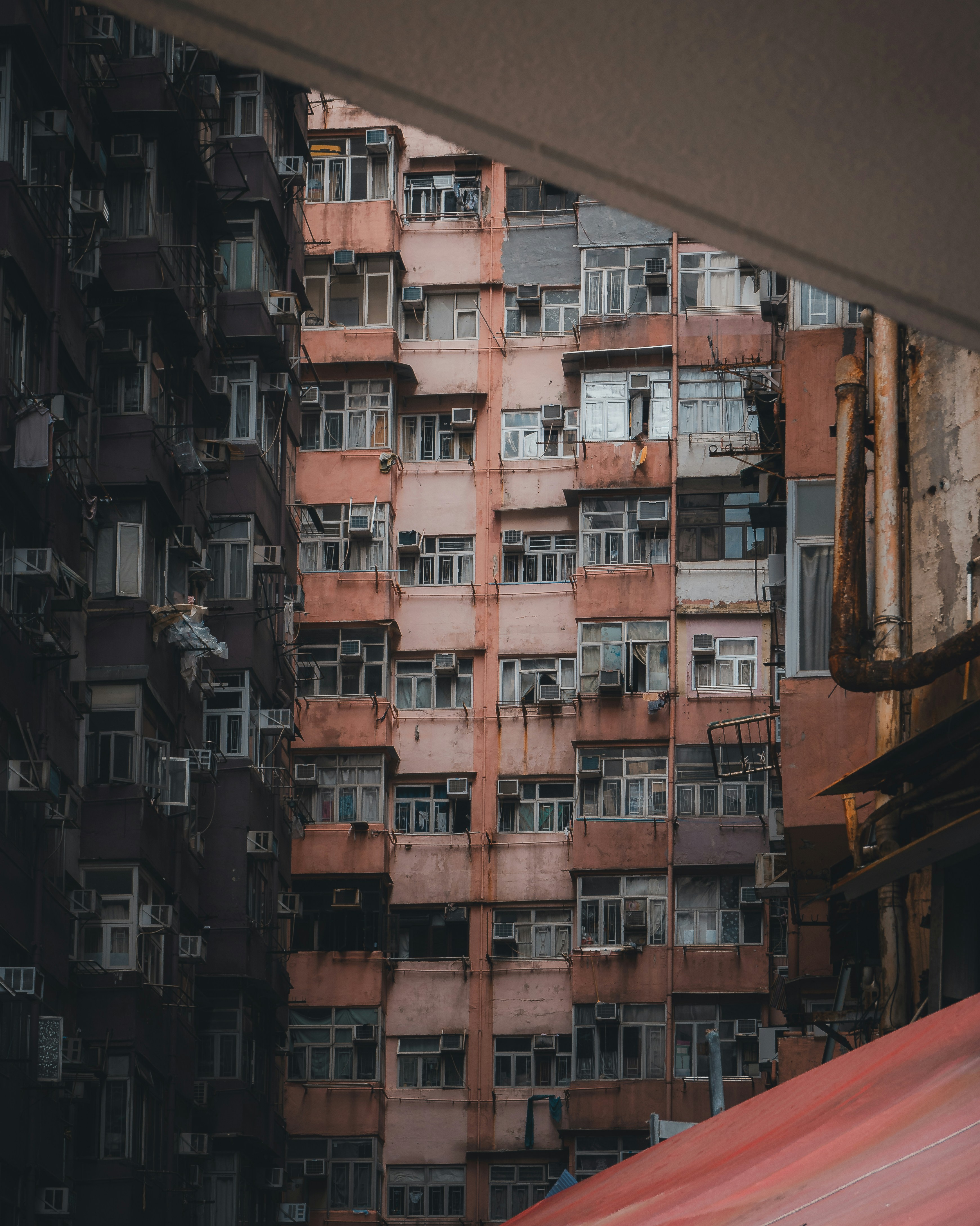 Dense residential apartment buildings with many windows and air conditioning units in Hong Kong