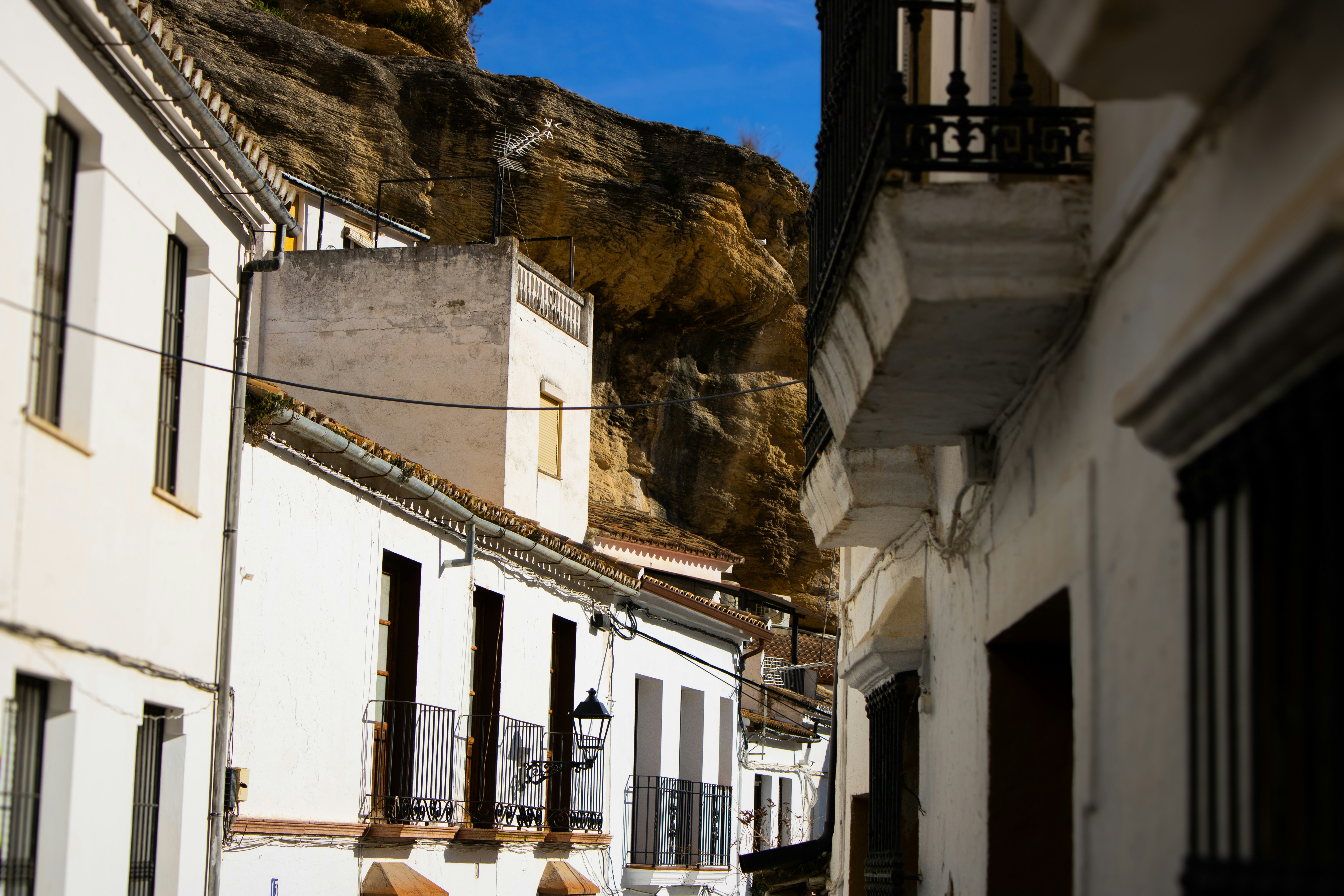 White houses beneath rocky cliff - Free Photo on Unsplash