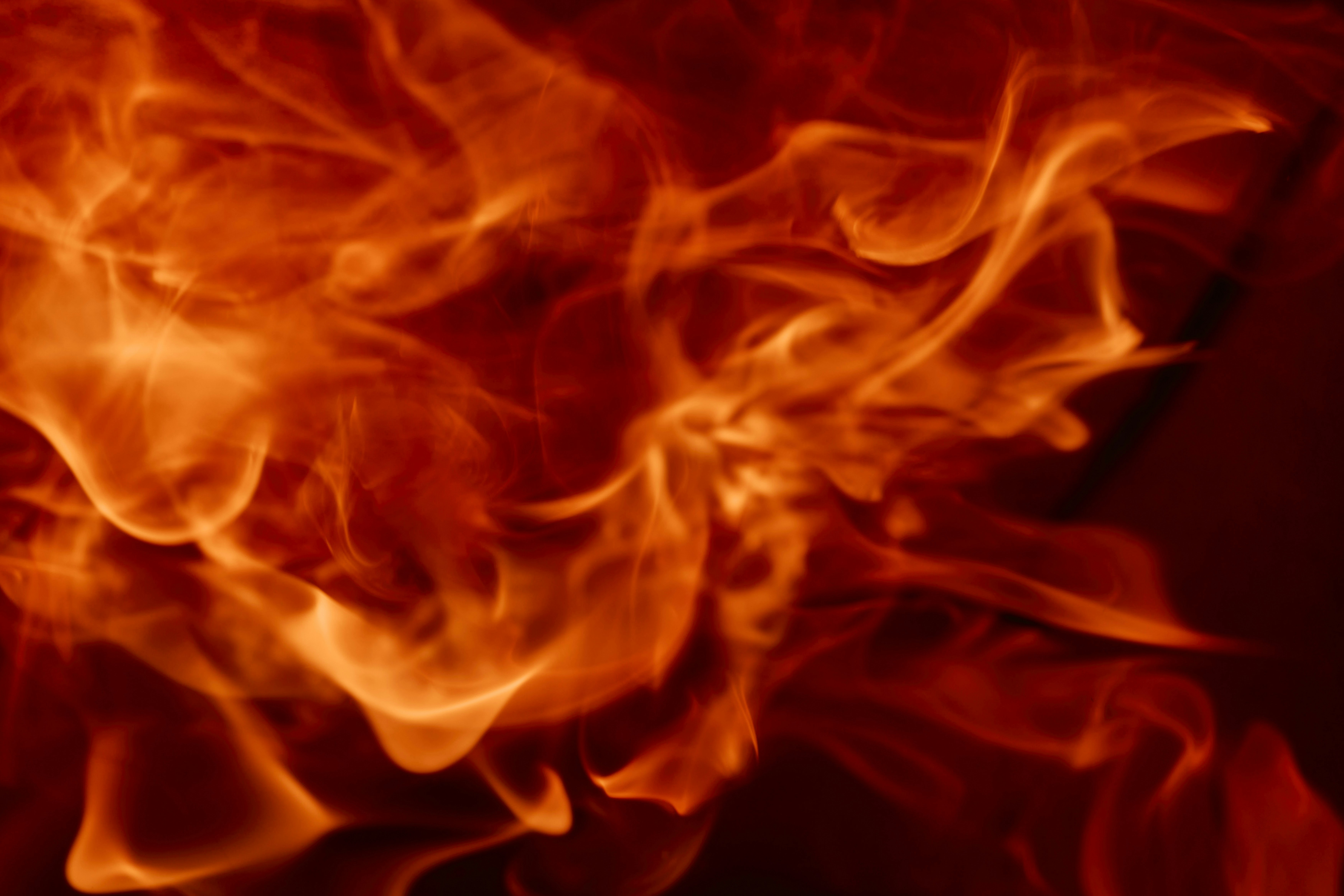 Bright orange and red flames swirling in a dark space