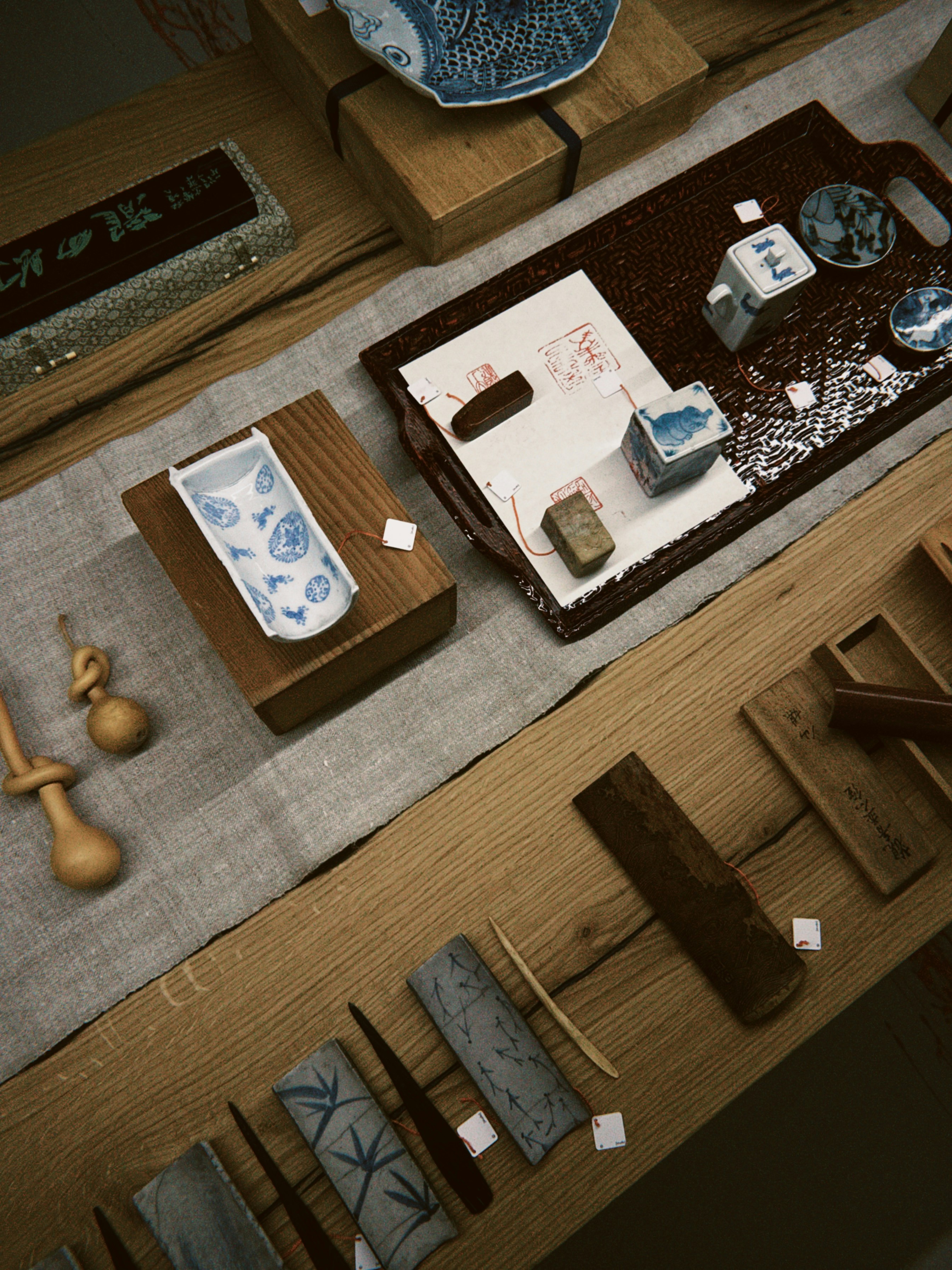 Traditional ink stones and ceramic tea accessories arranged on a wooden table