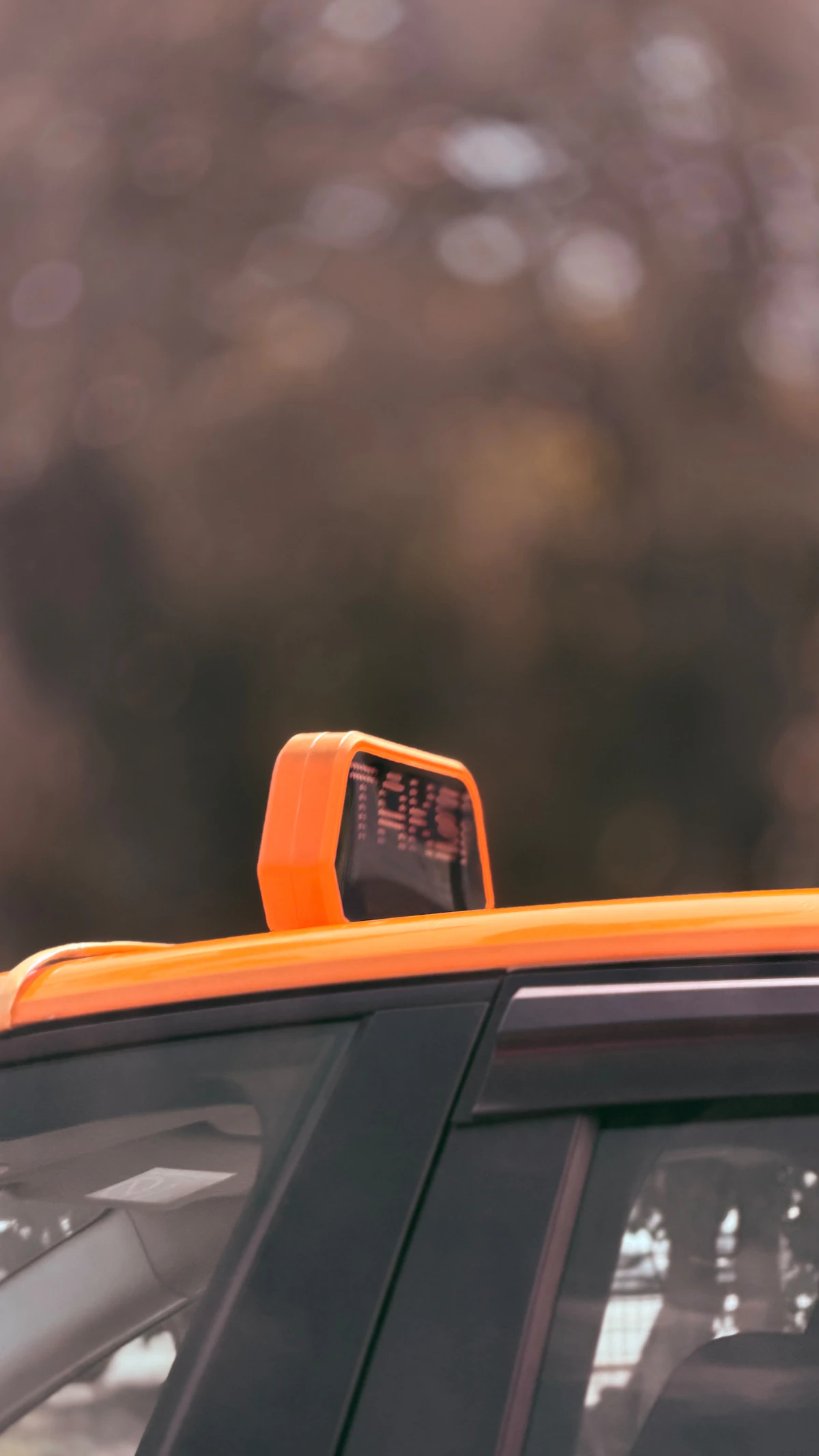 Taxi roof light against a blurred street