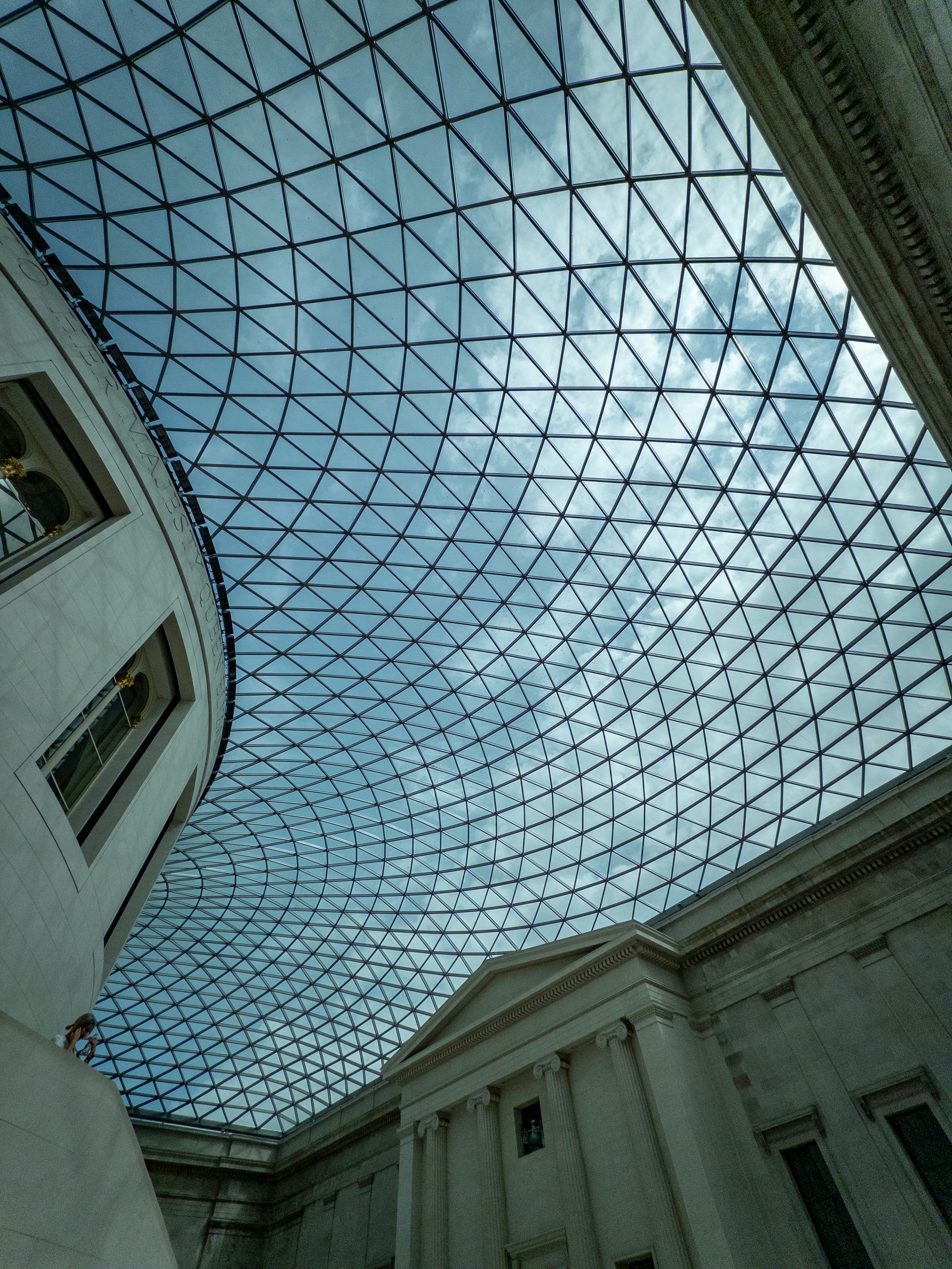 A glass and steel lattice roof over the Great Court in London