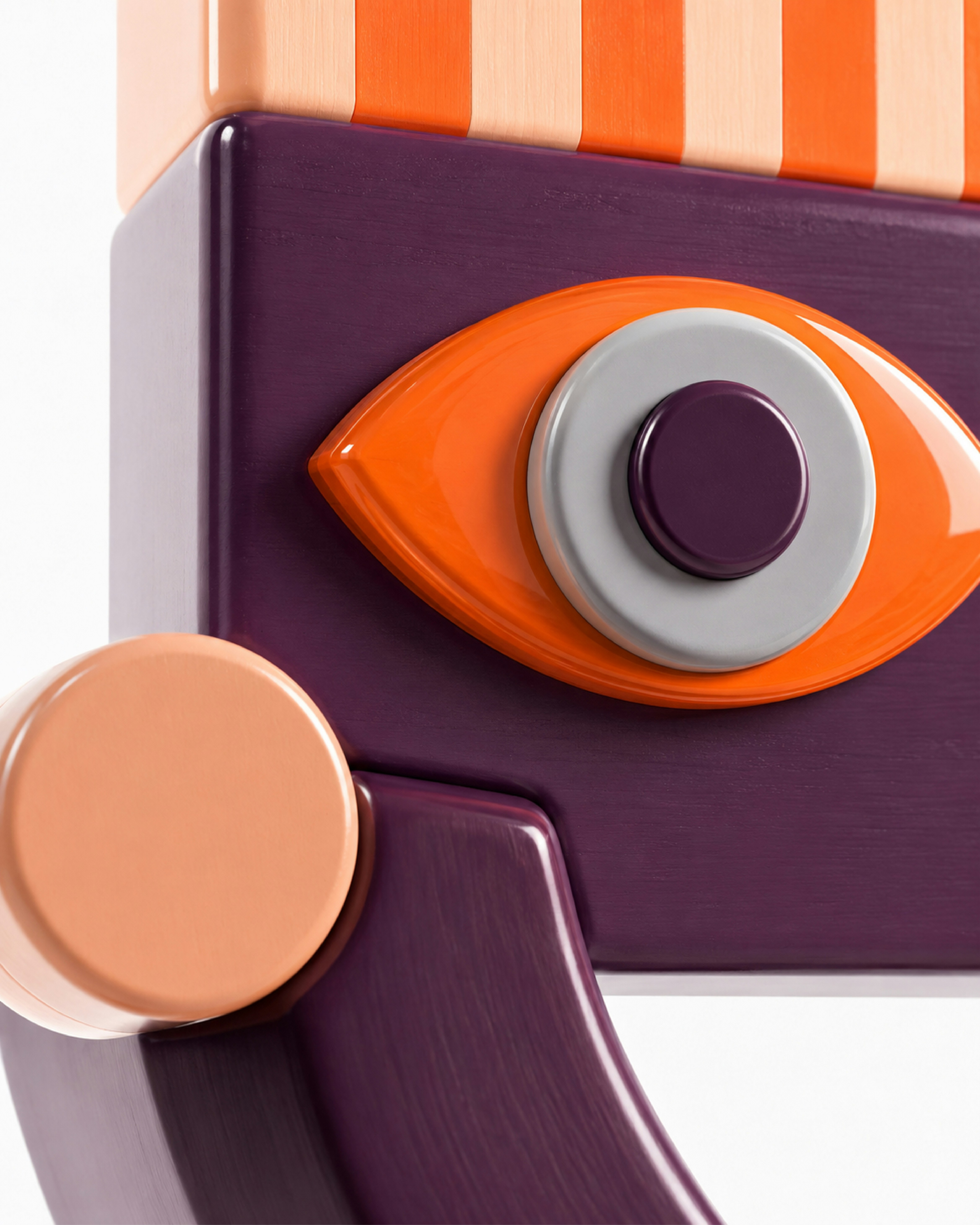A stylized purple wooden face with an orange eye and peach circular cheek