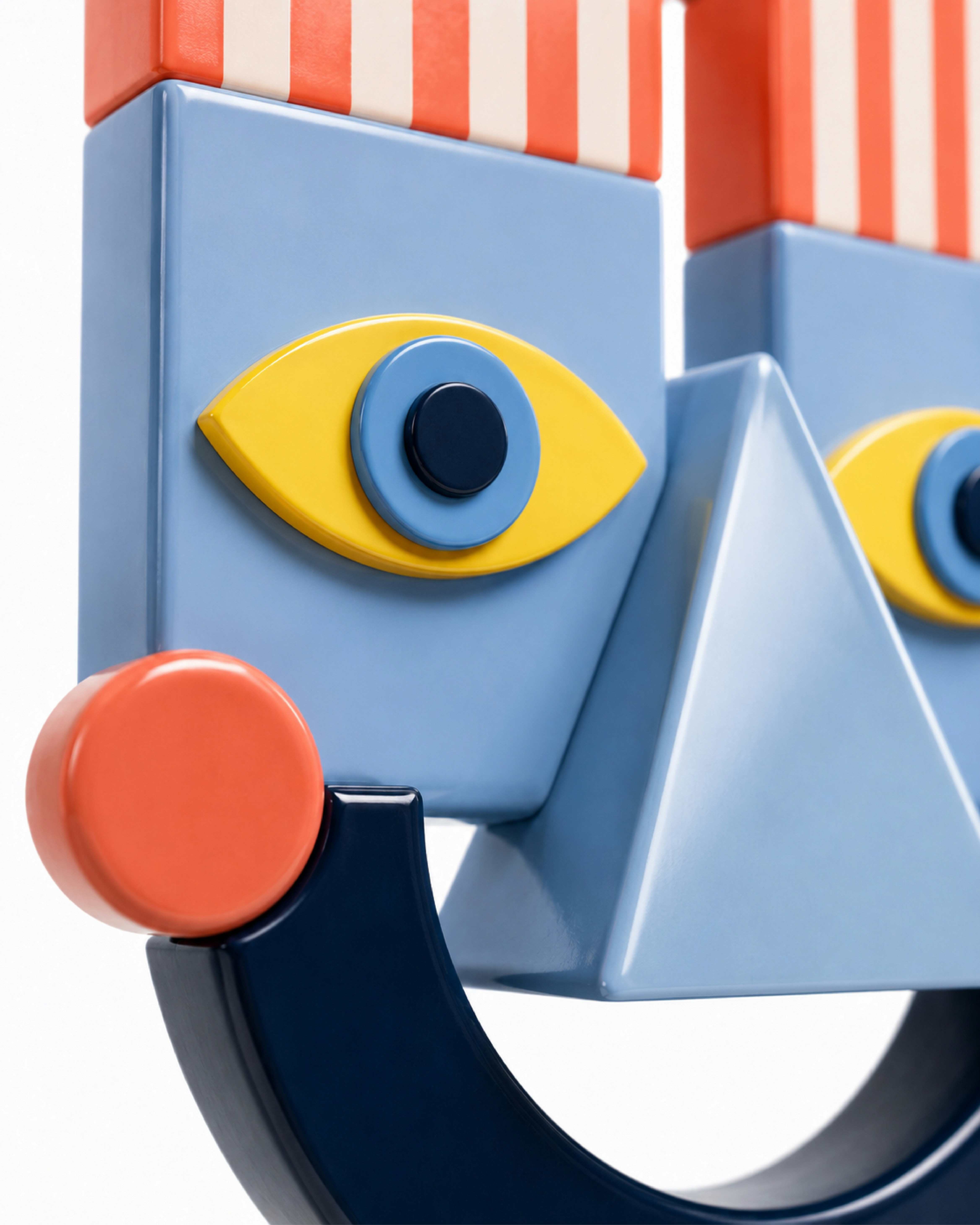 A stylized face sculpture with geometric blue, yellow, and orange shapes