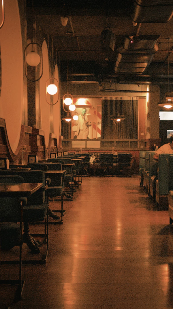 A warm, low-lit restaurant with booths