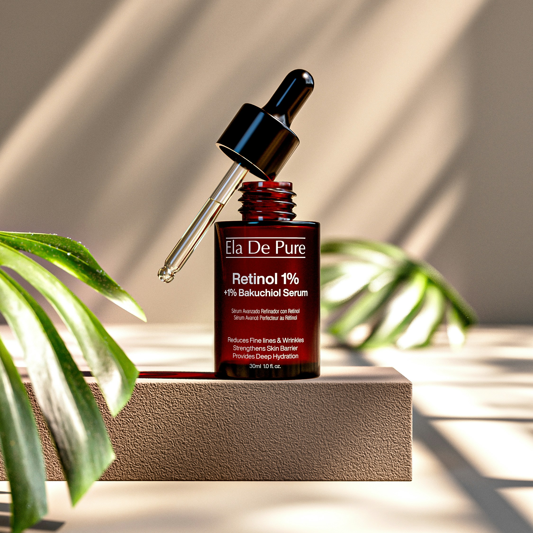 A brown glass serum bottle with a dropper beside a green leaf