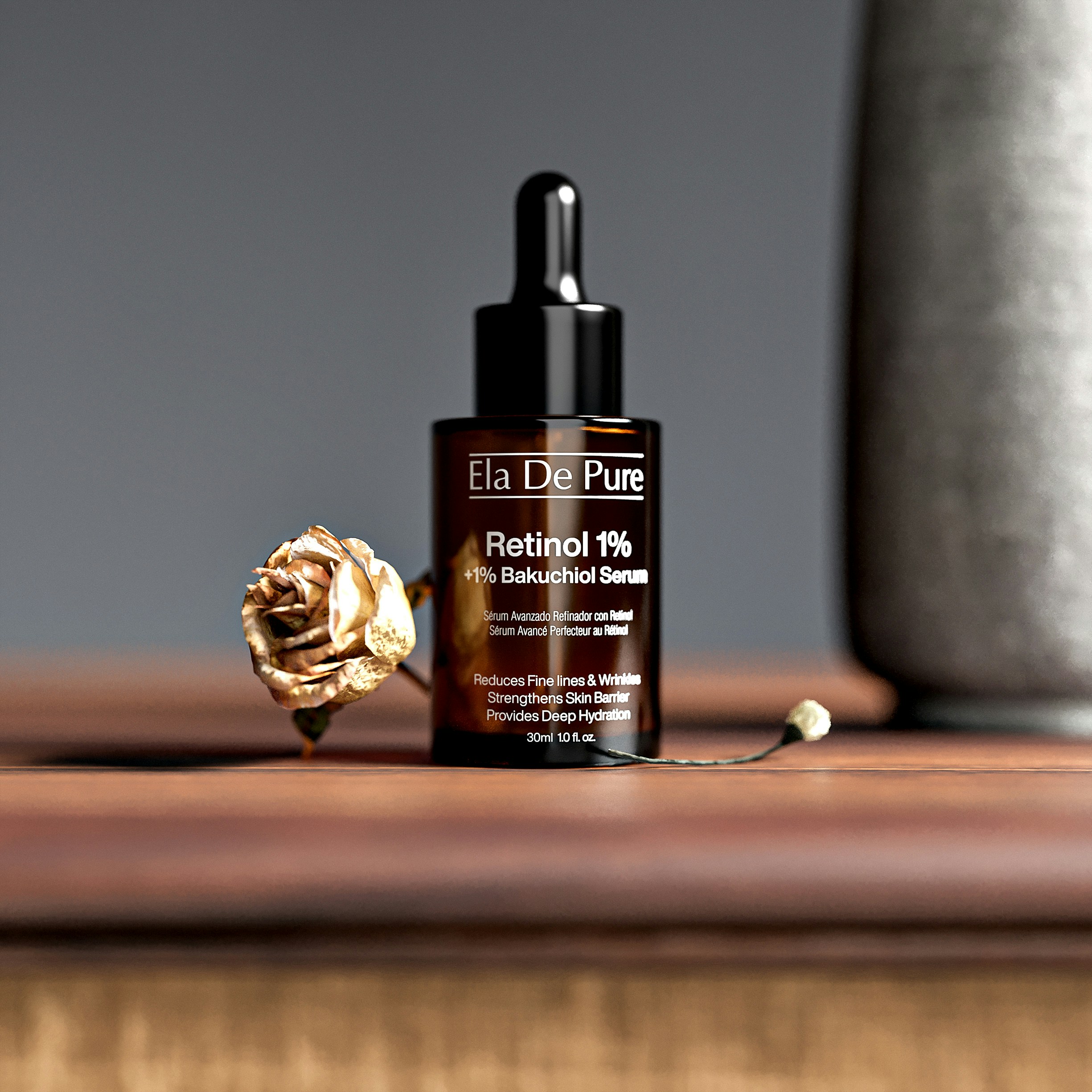 A brown glass dropper bottle of serum beside a dried golden rose
