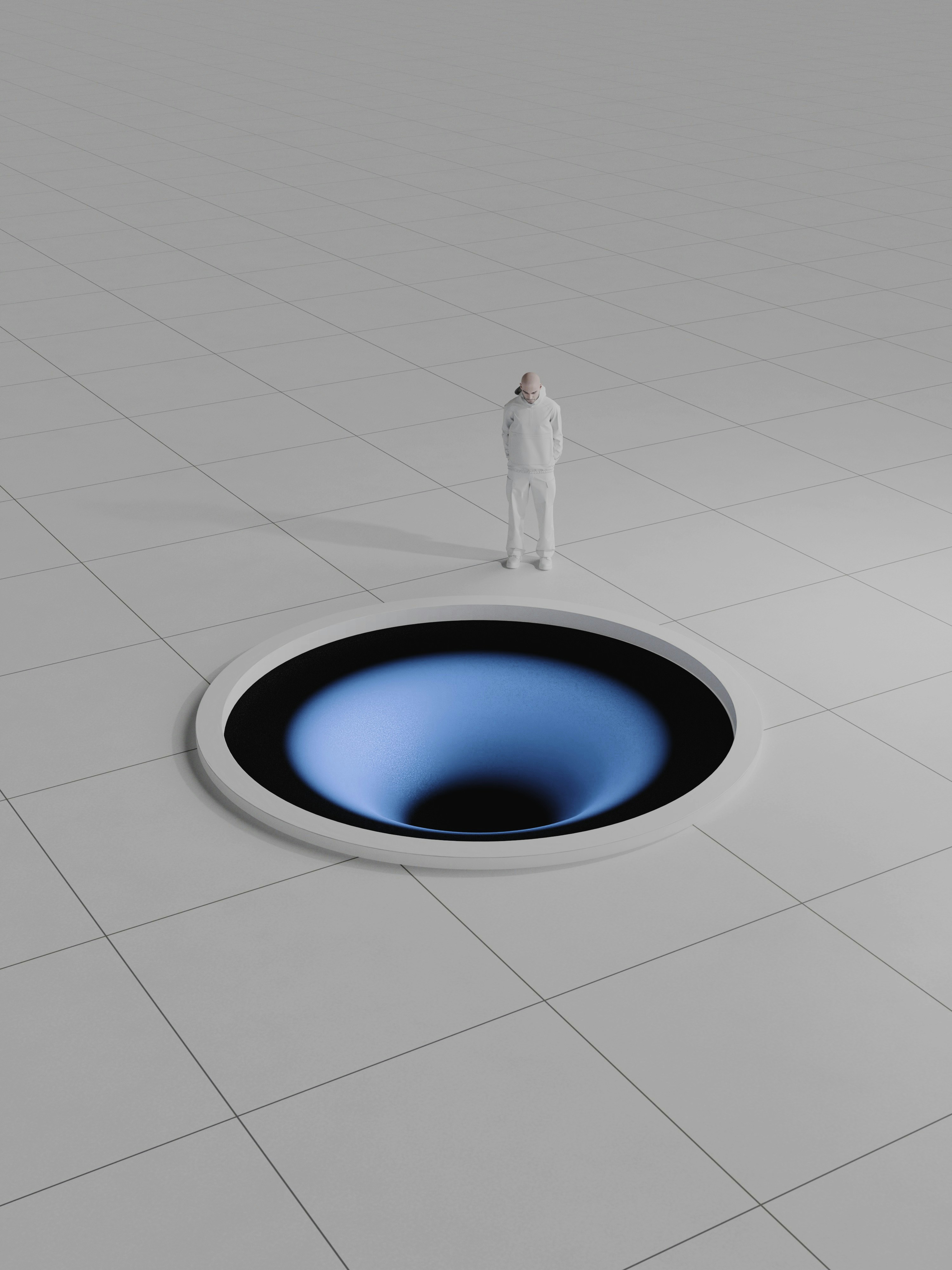 A person in white clothing looking into a glowing blue circular hole in the floor