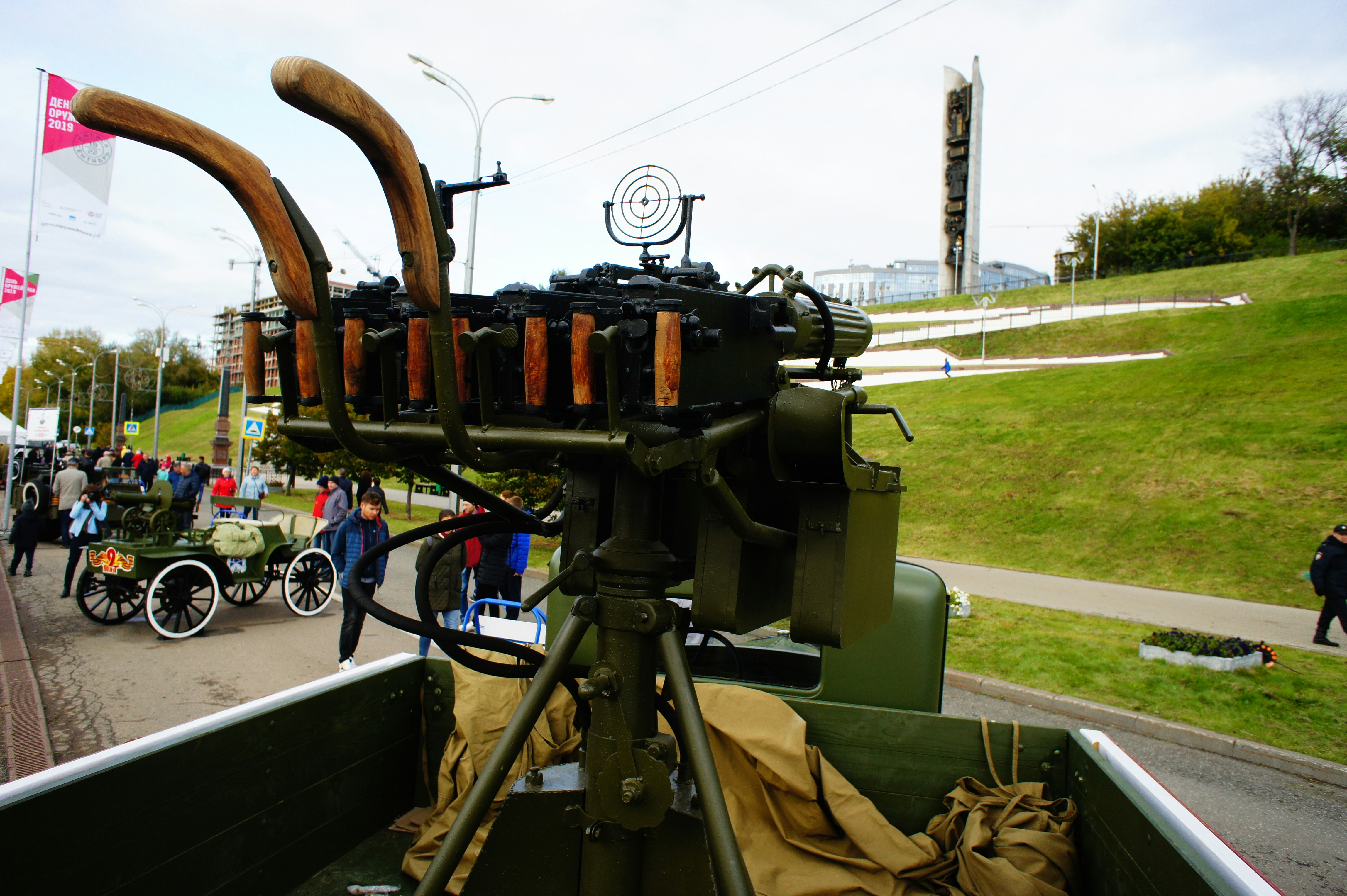 A vintage anti-aircraft machine gun mounted on a truck in a public park