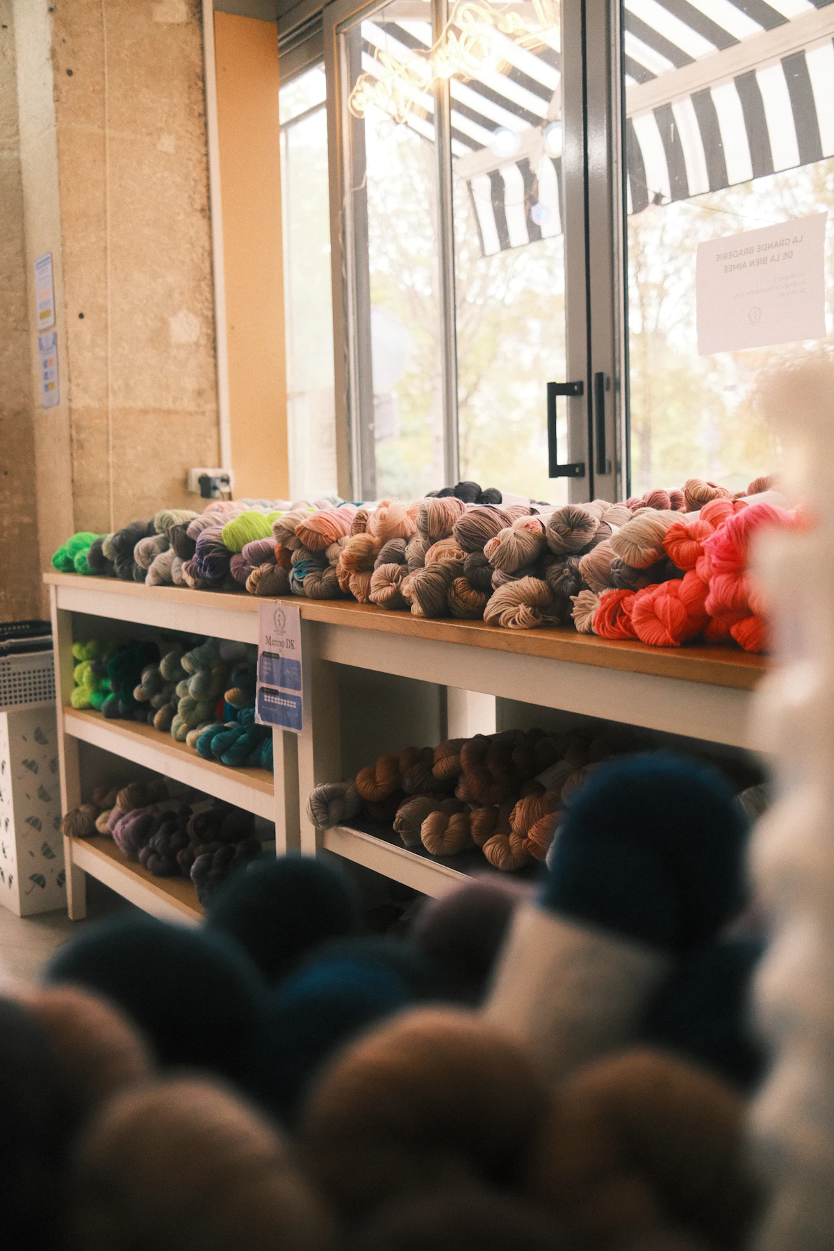 Yarn skeins on wooden shelves in a craft shop
