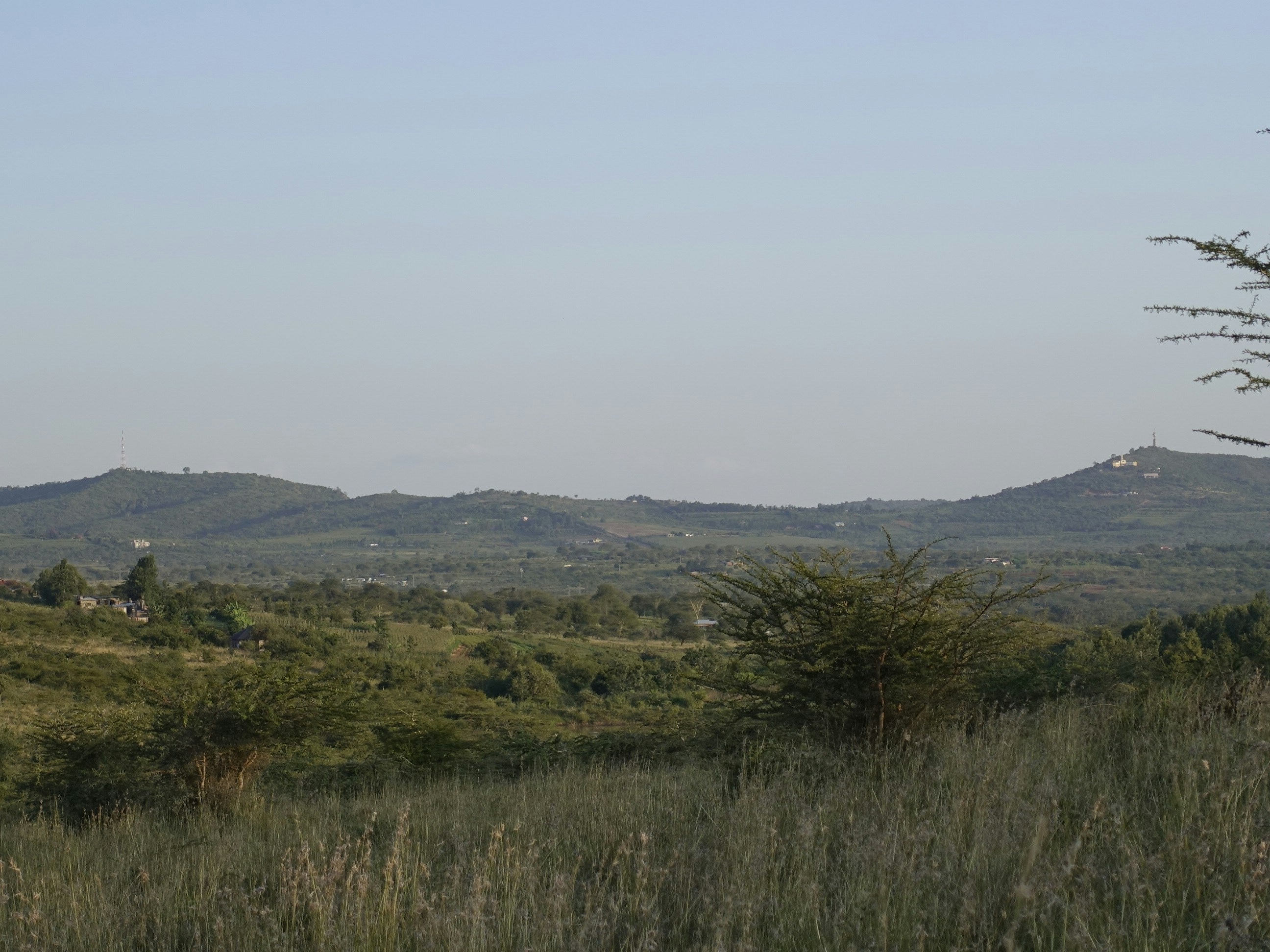 Traveler with camera overlooking Tanzania hills