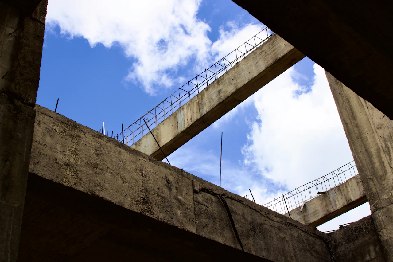 Concrete beams with exposed reinforcing steel on a construction site