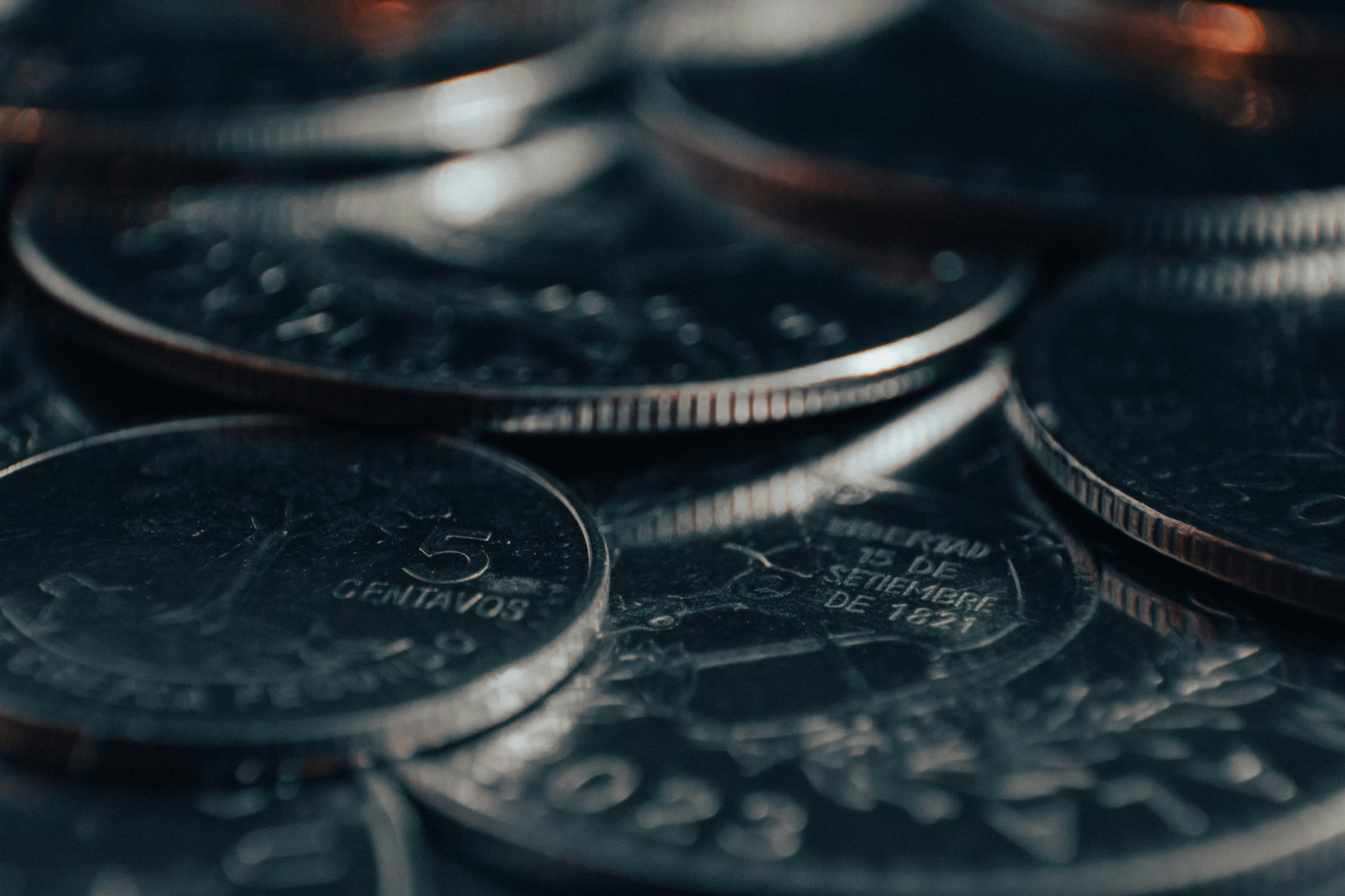 Close-up of silver coins in moody light