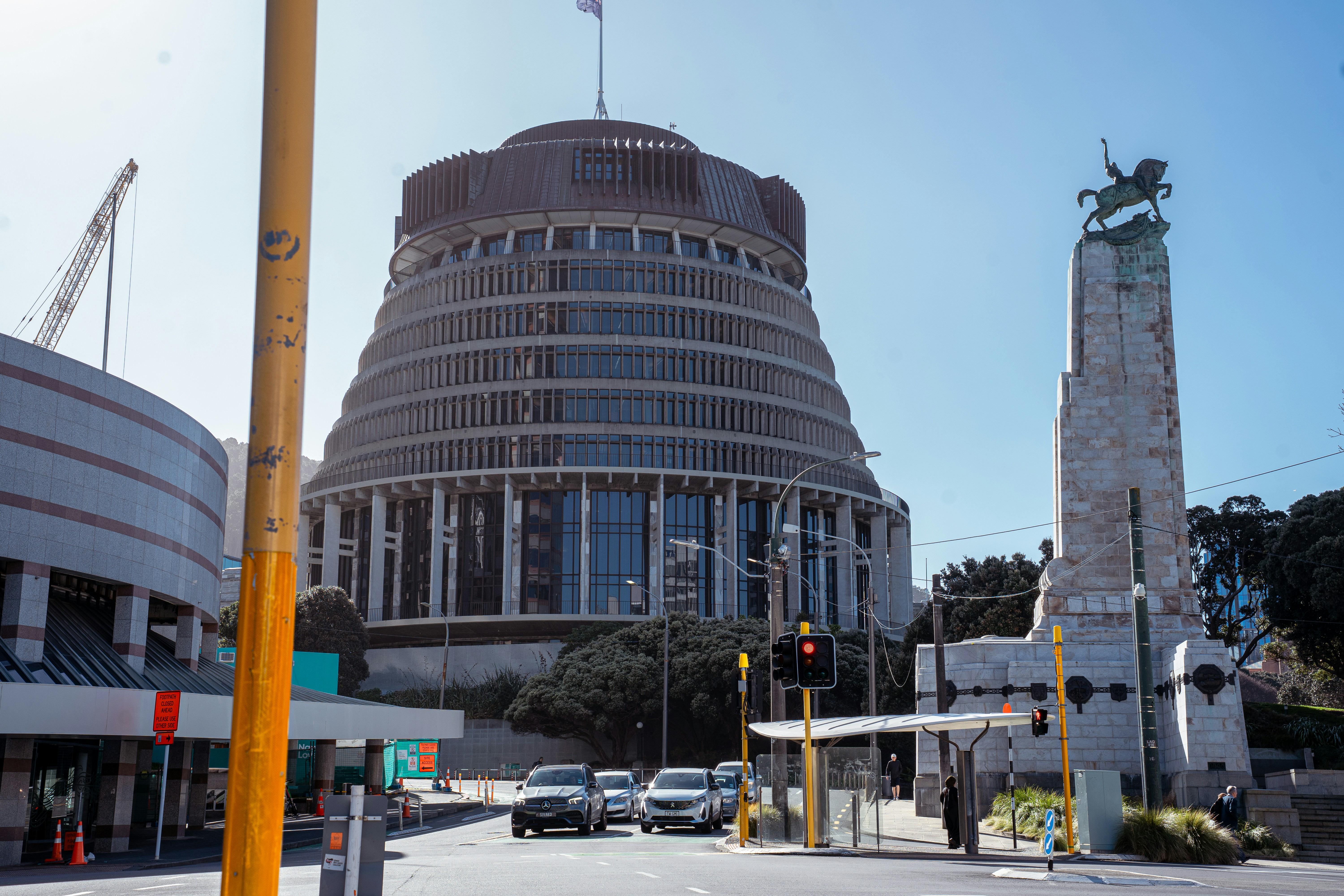 The Beehive building and a stone war memorial in Wellington, New Zealand