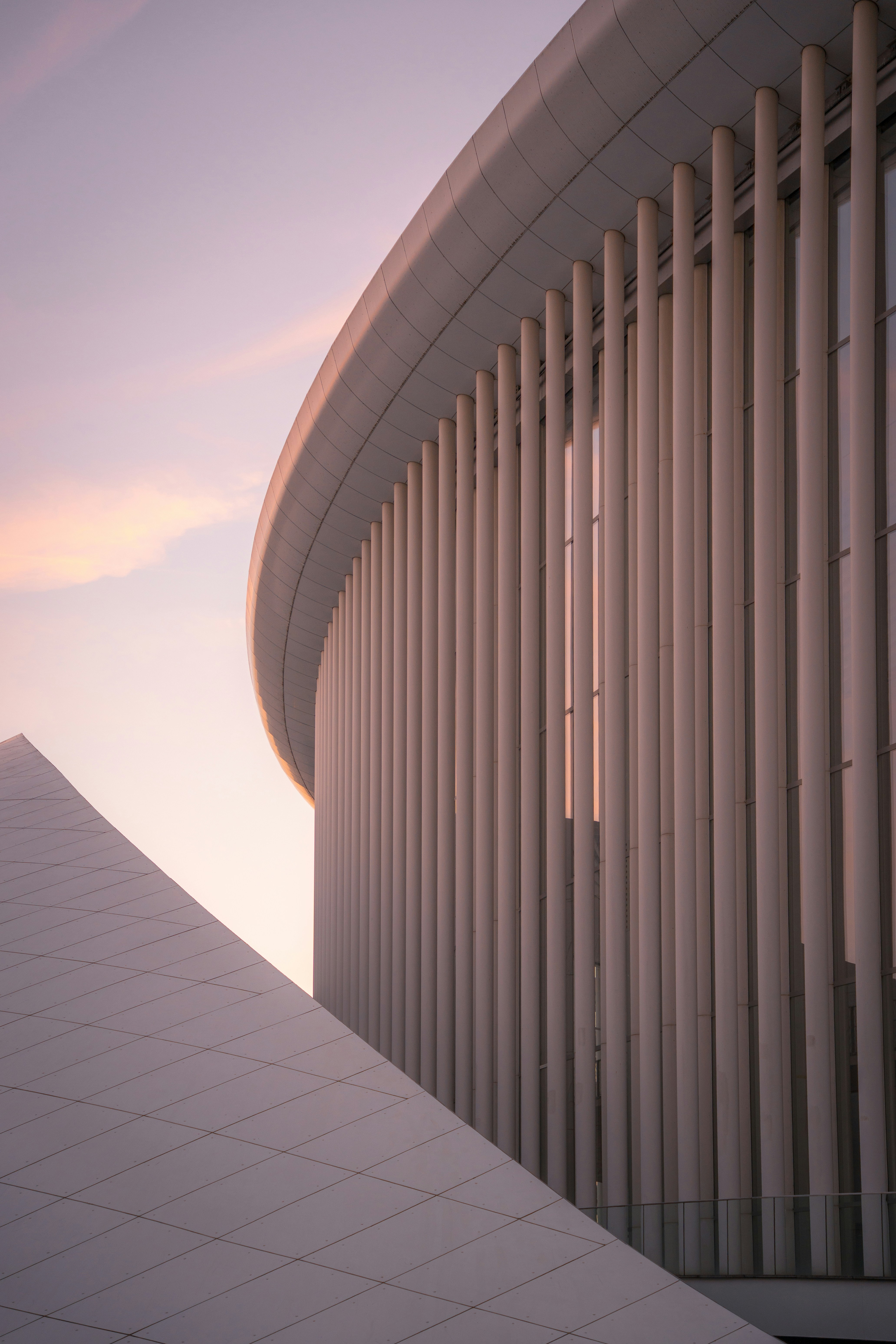Modern building with curved white columns and a triangular facade in Luxembourg