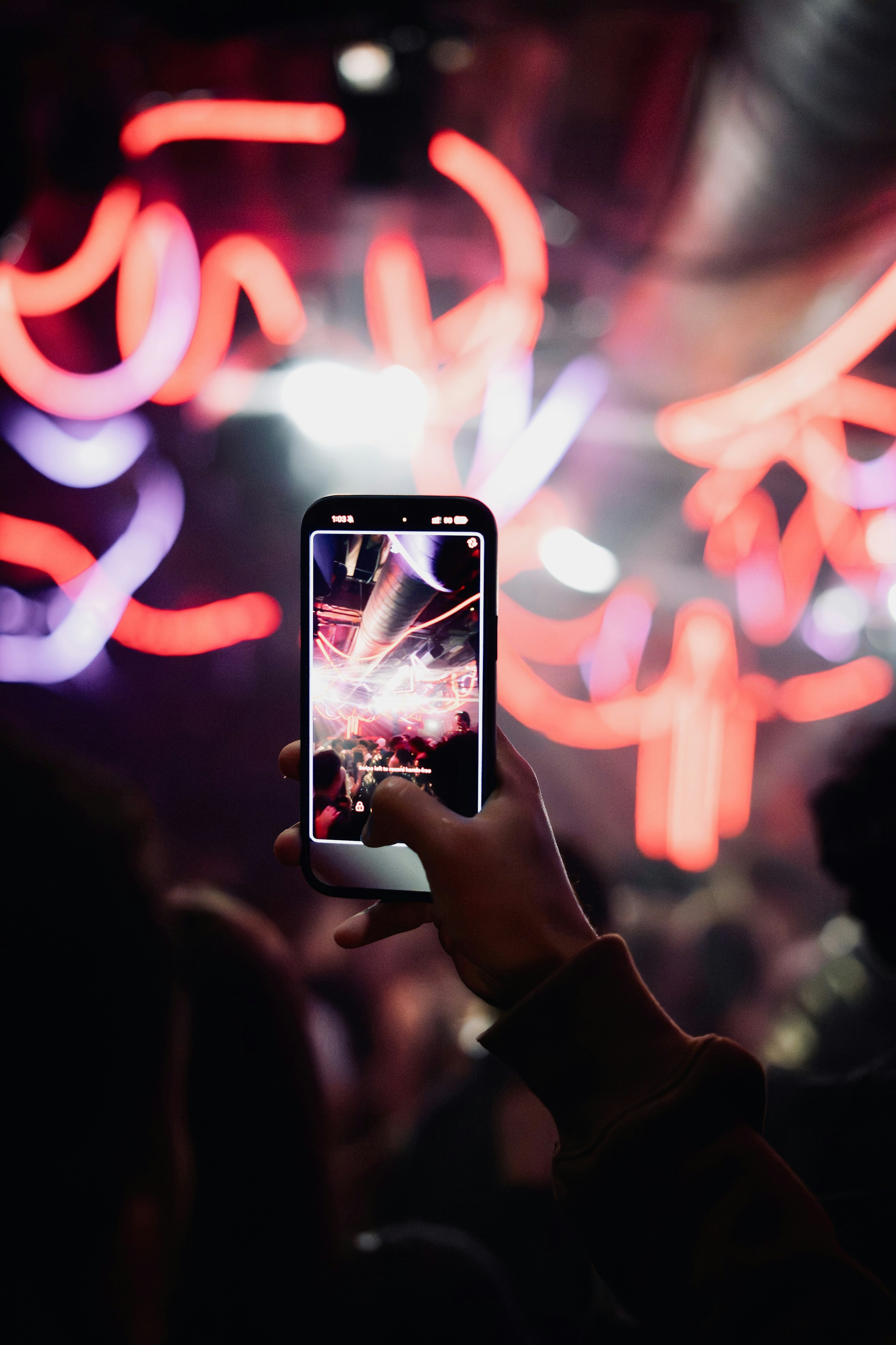 Phone recording under pink neon light